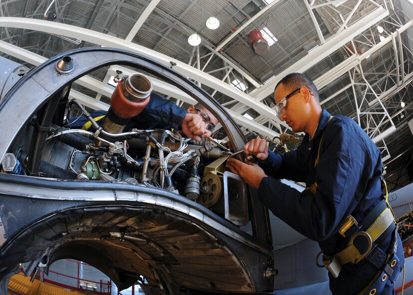 Airman 1st Class Eric Lopez and Airman 1st Class Marcos Morales from the 317th Maintenance Squadron clear debris and check for cracks on a C-130 Hercules during an inspection Oct. 20, 2011 at Dyess Air Force Base, Texas. Inspections are conducted yearly on C-130s ensuring mission readiness. (U.S. Air Force photo by Airman 1st Class Jonathan Stefanko/ Released)