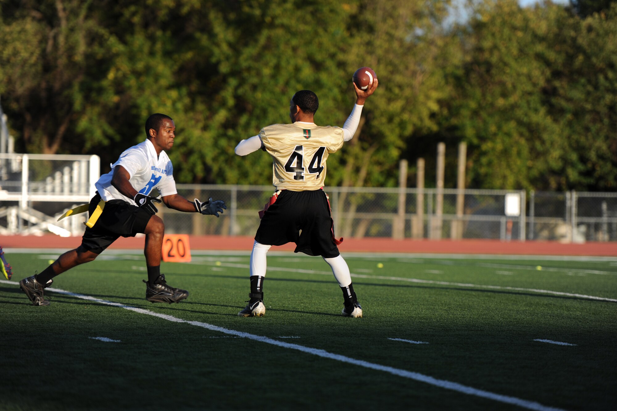 Jeremy Hoover, McConnell Team defensive line, challenges Dan Nickerson, Fort Riley Team quarterback, during a flag football game at Panther Field, Oct. 15, 2011, Derby, Kan.  The Air Force prevailed over Fort Riley 20-18.  The game was the third annual contest between the two teams and the McConnell’s first win.  (U.S. Air Force photo/Airman 1st Class Maurice Hodges)