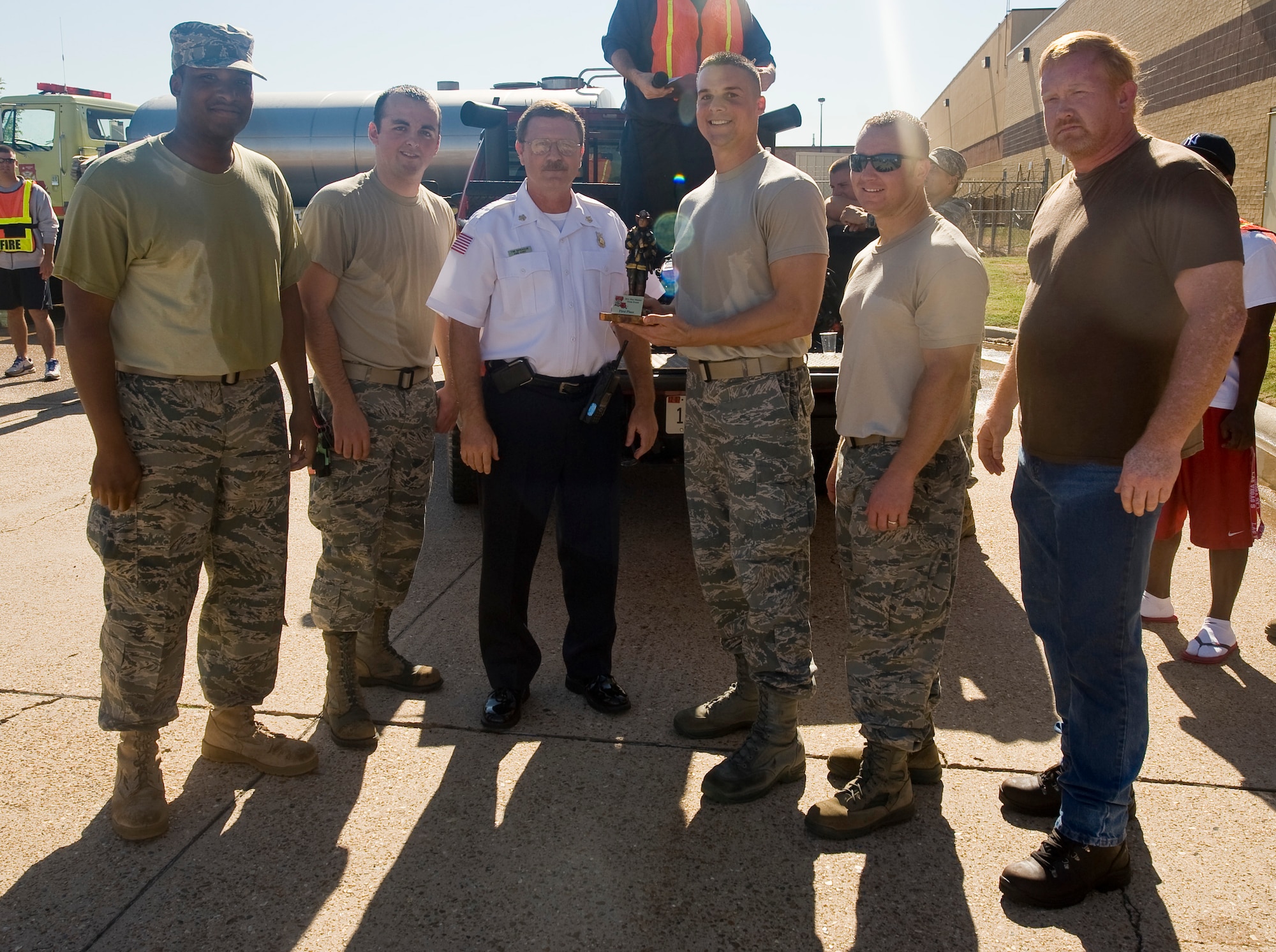The 2nd Medical Group team receives the first-place trophy following the 2nd Bomb Wing Fire Muster on Barksdale Air Force Base, La., Oct. 14. The competitors, from left to right: Airman 1st Class Donald Mears, Senior Airman Alexander Roberts, 1st Lt. Benjamin Meighan, Tech. Sgt. Chad Brock and Pat Holland (U.S. Air Force photo/Senior Airman Chad Warren)(RELEASED)
