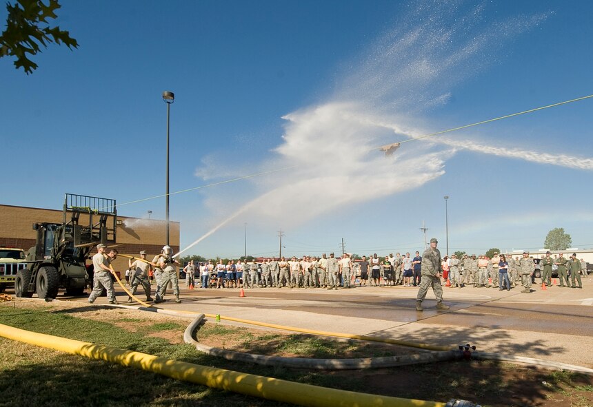Teams compete in a hose joust competition during the 2nd Bomb Wing Fire Muster on Barksdale Air Force Base, La., Oct. 14. During this final event of the muster, teams used water streams to push a sliding target into an opposing team's area. (U.S. Air Force photo/Senior Airman Chad Warren)(RELEASED)