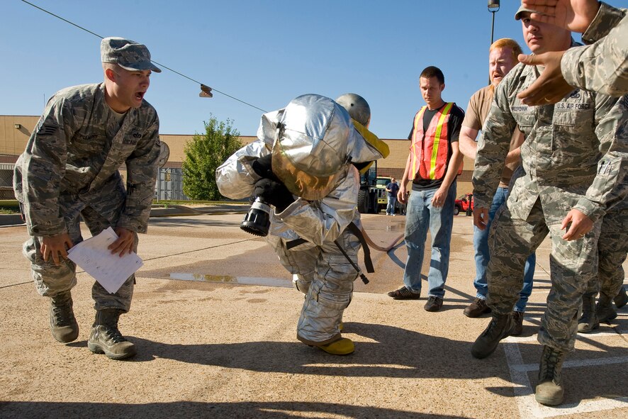 A competitor in the "backdraft bull" drags a fire hose during the 2nd Bomb Wing Fire Muster on Barksdale Air Force Base, La., Oct. 14. This portion of the competition consisted of individuals completing a strength and endurance course without the help of teammates. (U.S. Air Force photo/Senior Airman Chad Warren)(RELEASED)