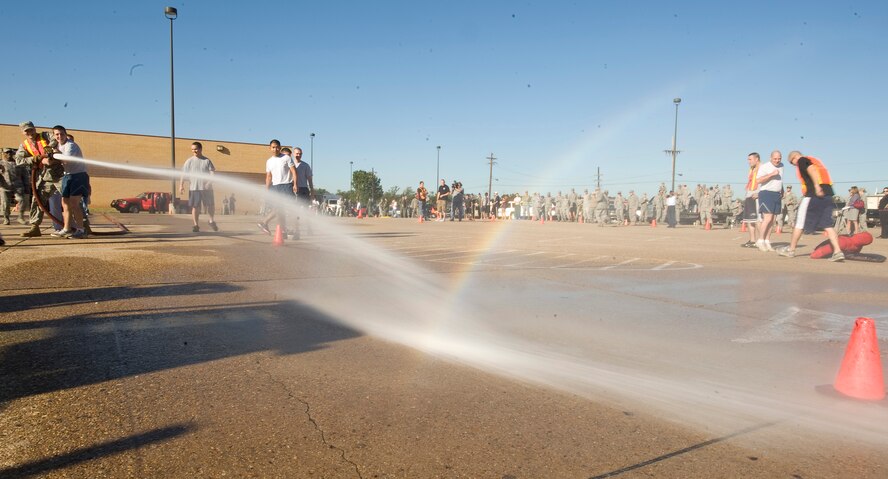 A member of the 2nd Force Support Squadron team operates a fire hose during the 2nd Bomb Wing Fire Muster on Barksdale Air Force Base, La., Oct. 14. Operating the hose was one of several fire-fighter related events competitors completed throughout the course. (U.S. Air Force photo/Senior Airman Chad Warren)(RELEASED)