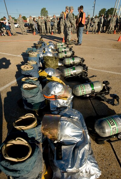Event coordinators prepare fire equipment prior to the start of the 2nd Bomb Wing Fire Muster on Barksdale Air Force Base, La., Oct. 14. This competition allowed Barksdale Airmen to compete as a team or individually in fire-fighter related competitions, such as operating a fire hose and carrying a dummy to safety. (U.S. Air Force photo/Senior Airman Chad Warren)(RELEASED)