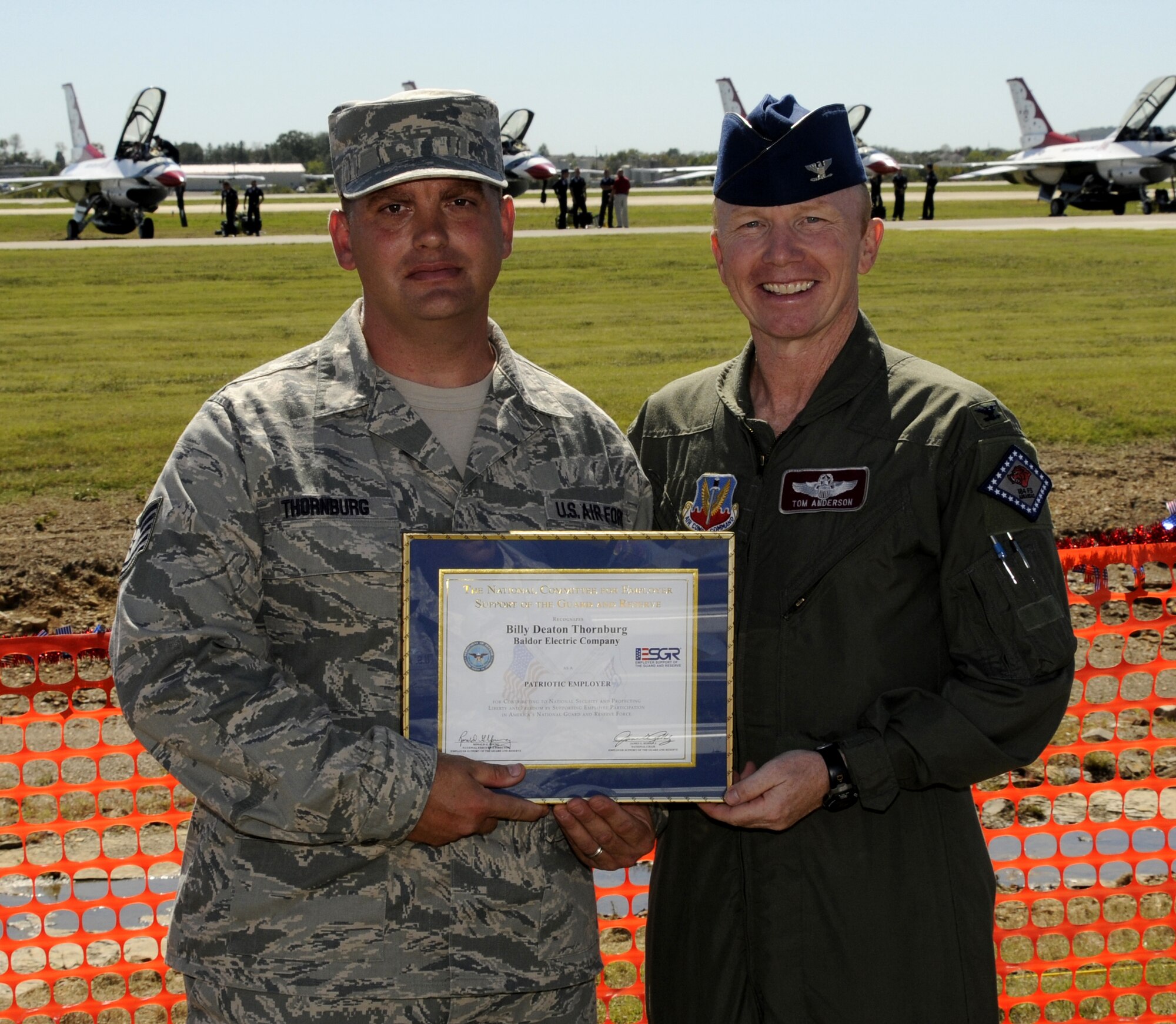 Tech Sgt. Billy Thornburg, 188th Fighter Wing member and Baldor employee, left, and Col. Tom Anderson, 188th Fighter Wing commander pose for a photo. Baldor was recognized with an Employer Support of the Guard and Reserve (ESGR) Patriot Award Sept. 30 at the 188th Fighter Wing. The accolade honors employers that have exhibited immense support of their employees’ careers in the National Guard or Reserves. (U.S. Air Force photo by Senior Master Sgt. Dennis Brambl/188th Fighter Wing Public Affairs)