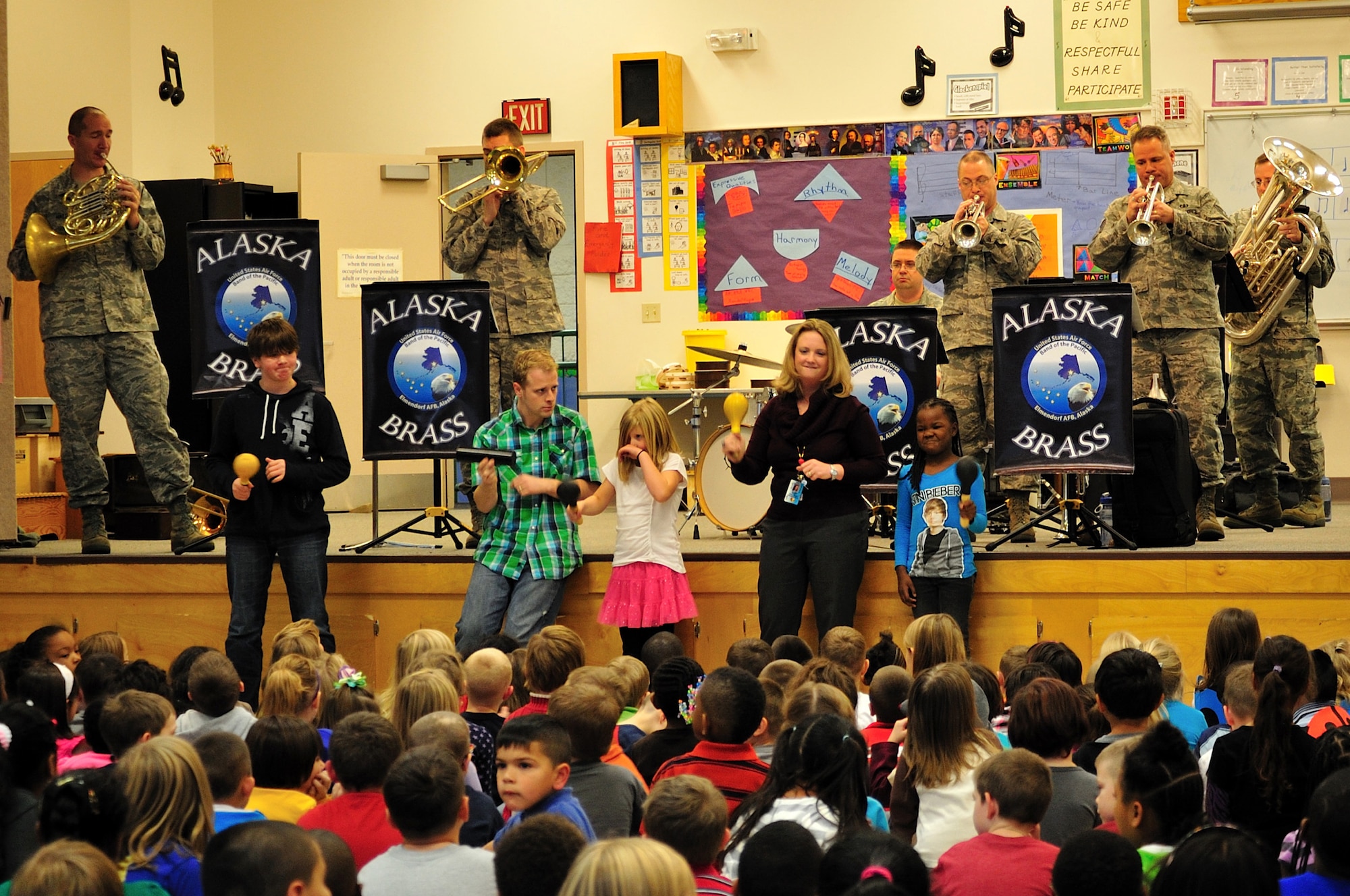 Students and faculty from Ursa Major Elementary School assist the U.S. Air Force Band of the Pacific Alaska Brass members as they perform for grades K-6 on Joint Base Elmendorf-Richardson, as part of the Red Ribbon week, Oct. 19. The band performed at different schools to support the message of this year's drug-free campaign, "It's up to me to be drug free." (U.S. Air Force photo/Staff Sgt. Sheila deVera)