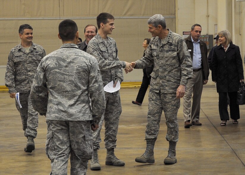 Air Force Chief of Staff Gen. Norton Schwartz shakes hands with Airman 1st Class Edward Strother, 2nd Comptroller Squadron, during a civic leader tour on Barksdale Air Force Base, La., Oct. 18, 2011. Schwartz led a 15-member civic leader delegation during a tour of the 2nd Bomb Wing, 8th Air Force and Air Force Global Strike Command. The CSAF civic leader program is an Air Staff-level program comprised of respected community leaders selected by officials from Air Force major commands, the National Guard Bureau and Headquarters Air Force. (U.S. Air Force photo/Senior Airman Amber Ashcraft)(RELEASED)