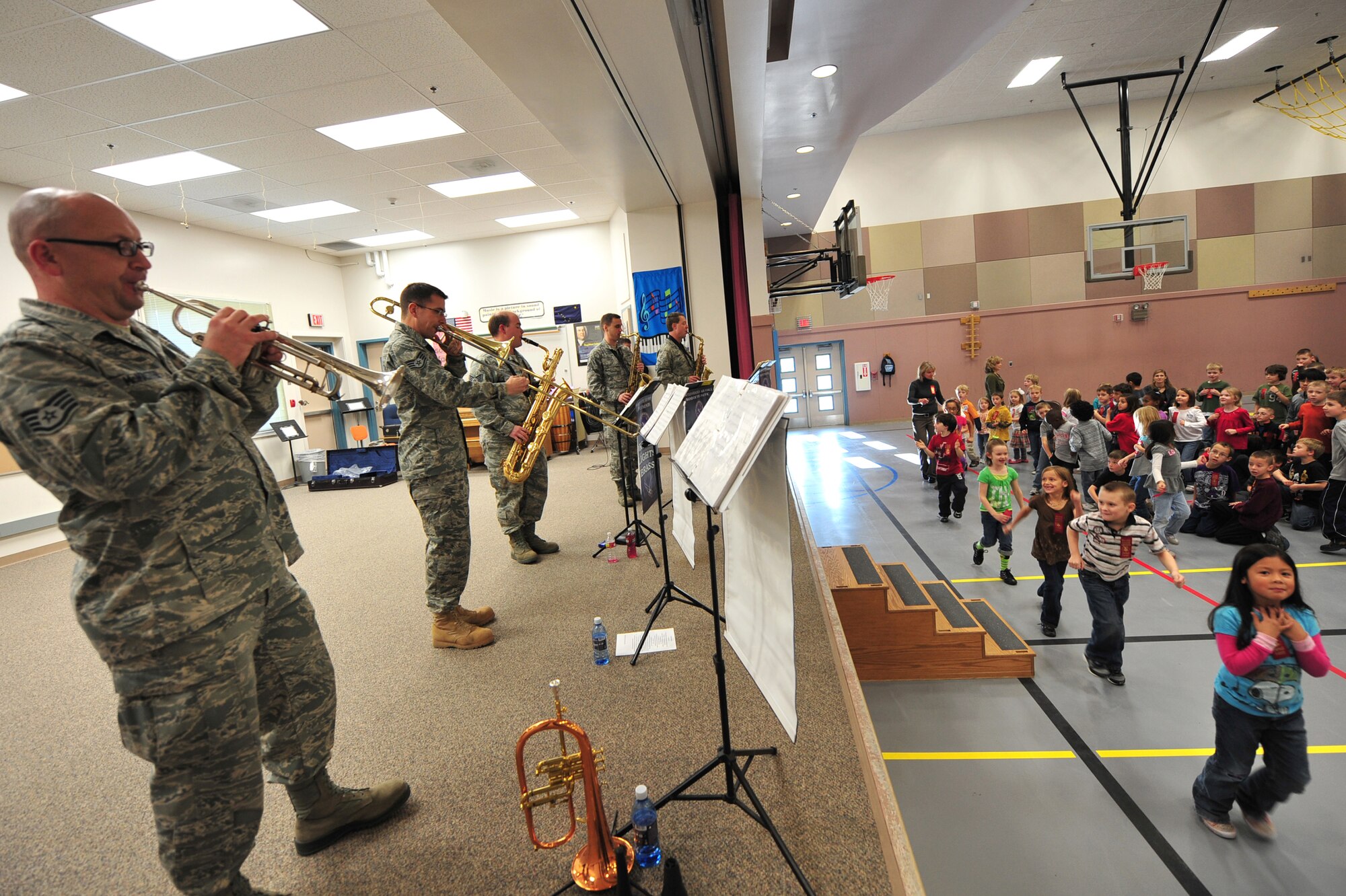 Students from Mt. Spurr Elementary School march back to their classroom as the Northern Lights Brass, part of the U.S. Air Force Band of the Pacific, performs during the Red Ribbon Week at Joint Base Elmendorf-Richardson, Oct. 12. The band performed at different schools to support the message of this year's drug-free campaign, "It's up to me to be drug free." (U.S. Air Force photo/Staff Sgt. Sheila deVera)(U.S. Air Force photo/Staff Sgt. Sheila deVera)
