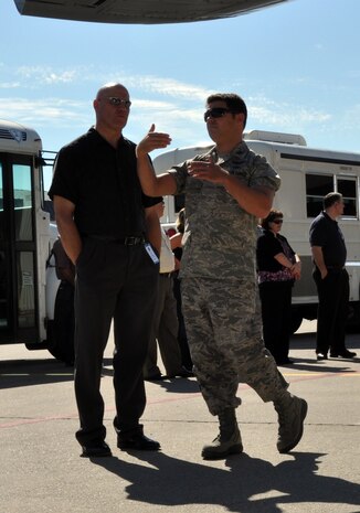 A captain from the 9th Operations Group explains how the shape of the wings of the MC-12W Liberty creates lift to Mayor John Dukes, Yuba City, Calif., mayor, at Dock 6 on the flight line Oct. 14 during Beale Day. The tour introduced more than 50 civic leaders from surrounding communities to key elements of Beale's mission. (U.S. Air Force Photo by Airman 1st Class Shawn Nickel) 
