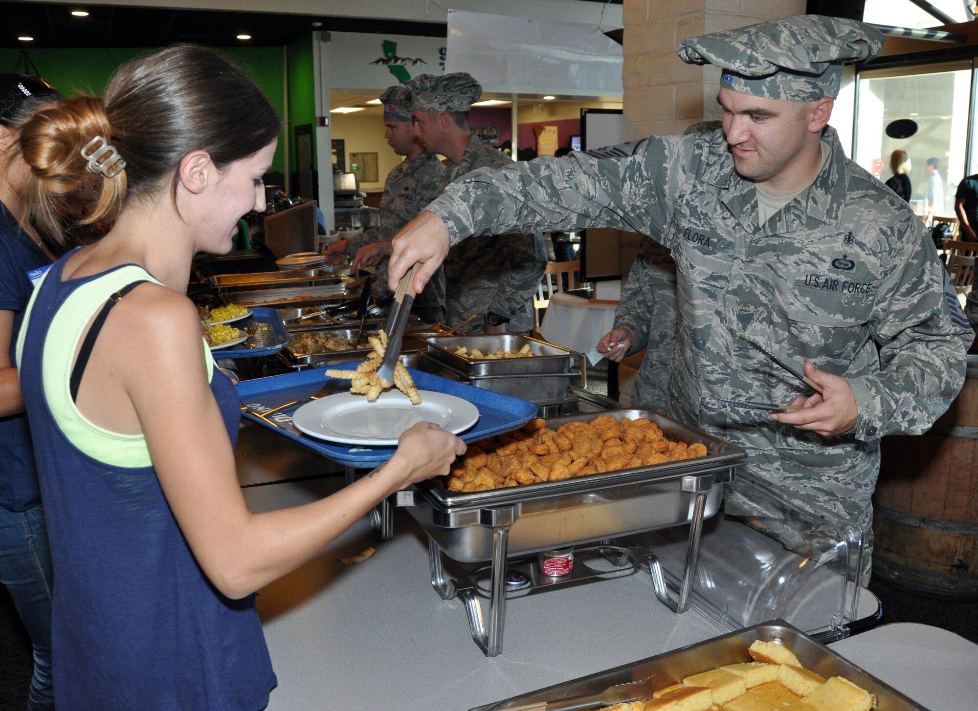 Master Sgt. Andrew Flora, 9th Maintenance Operations Squadron first sergeant, serves food to a spouse of a deployed Airman during the Hearts Apart Dinner at the Contrails Inn Dinning Facility Oct. 13. The pirate themed dinner and was hosted by the Airman and Family Readiness Center together with Beale's first sergeants. (U.S. Air Force photo by Airman 1st Class Shawn Nickel)