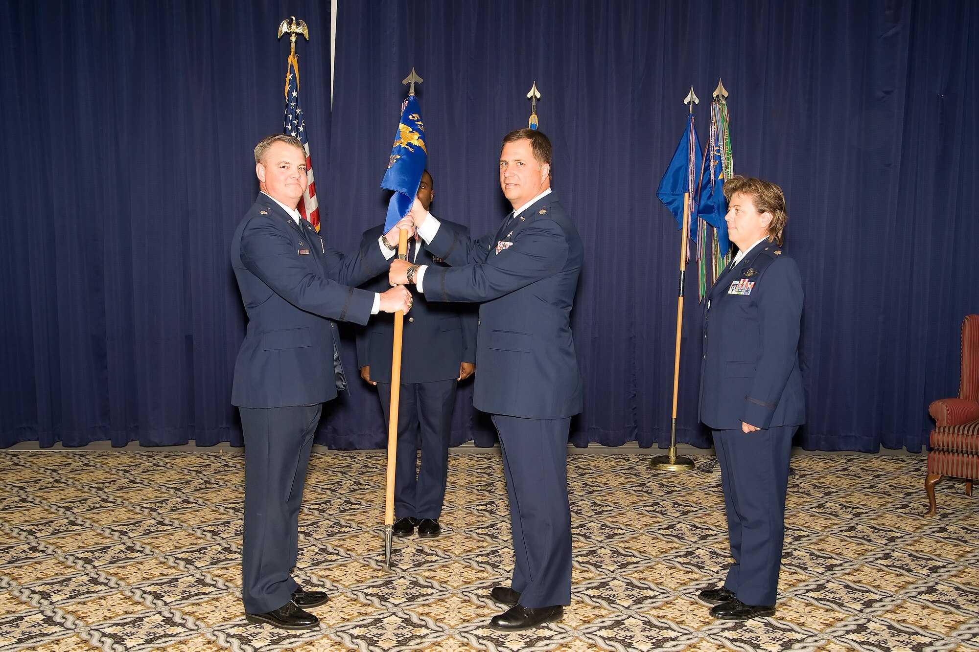 Lt. Col. Derin S. Durham, 512th Operations Group commander, passes the guidon to Lt. Col. Andrew J. Eiler who assumed command of the 512th Operations Support Flight here at the Landings, Oct 16. (U.S. Air Force photo/Adrian Rowan)
