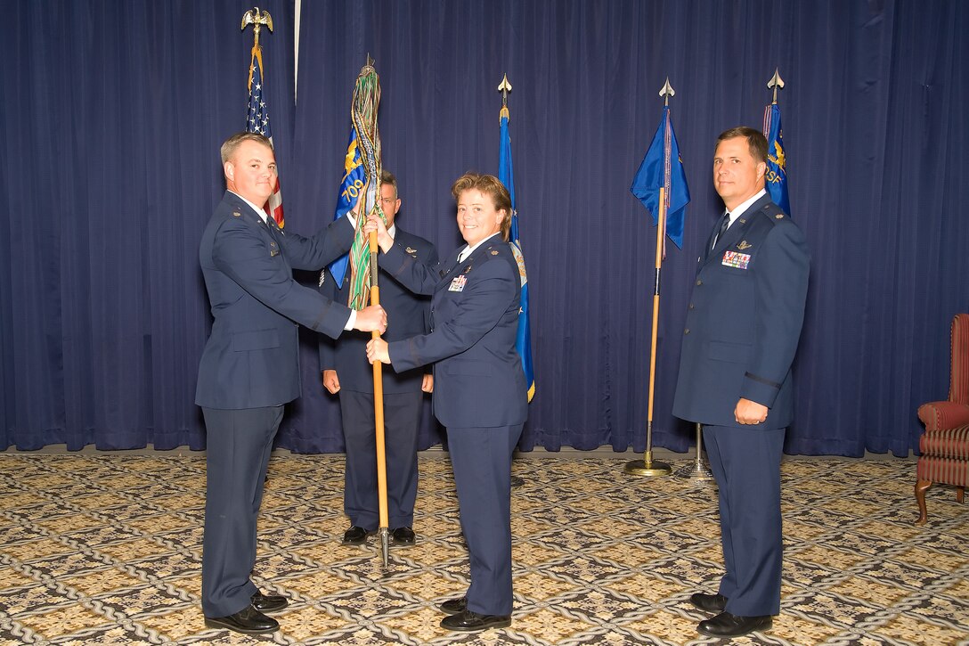 Lt. Col. Derin S. Durham, 512th Operations Group commander, passes the guidon to Lt. Col. Theresa L. Cave who assumed command of the 709th Airlift Squadron here at the Landings, Oct.16.  (U.S. Air Force photo/ Adrian Rowan)