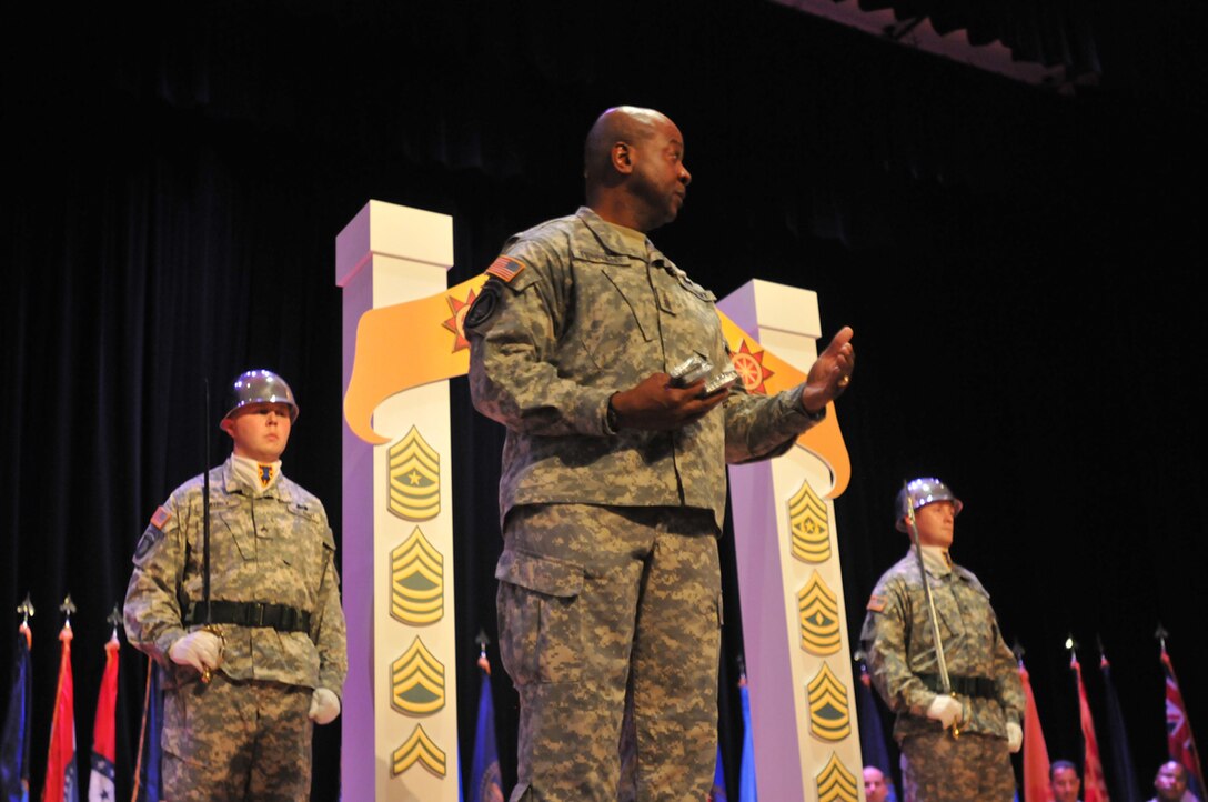 Command Sgt. Maj. Willie C. Tennant Sr., command sergeant major, 3rd Sustainment Command (Expeditionary), Fort Knox, Ky., and guest speaker for the 24th Transportation Battalion's NCO induction ceremony, addresses the audience of NCOs and Soldiers about what it means to be a leader and an NCO at Jacobs Theater Oct. 13. (U.S. Army photo by Pfc. Alex Kilmon/RELEASED)