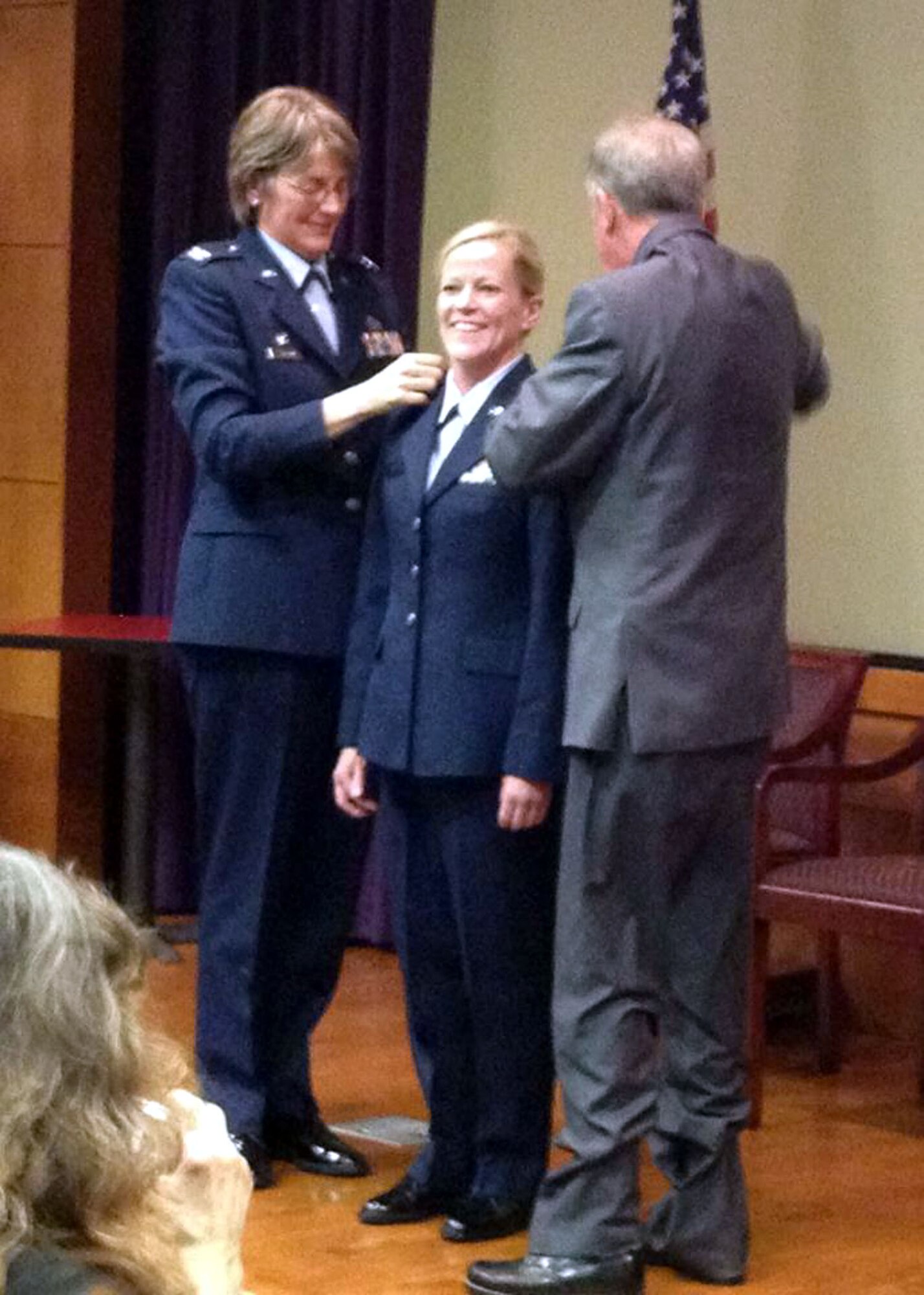 TRAVIS AIR FORCE BASE, Calif. --  Col. Nancy Brooks, Commander, 349th Mission Support Group hands over the squadron flag to Lt. Col. Cynthia A.Doolittle, Commander, 349th Civil Engineer Squadron, during a change of command ceremony held on October 15. The new commander also pinned on the rank of Lt. Col. assisted by her father and Col. Brooks. (U.S. Air Force courtesy photo)