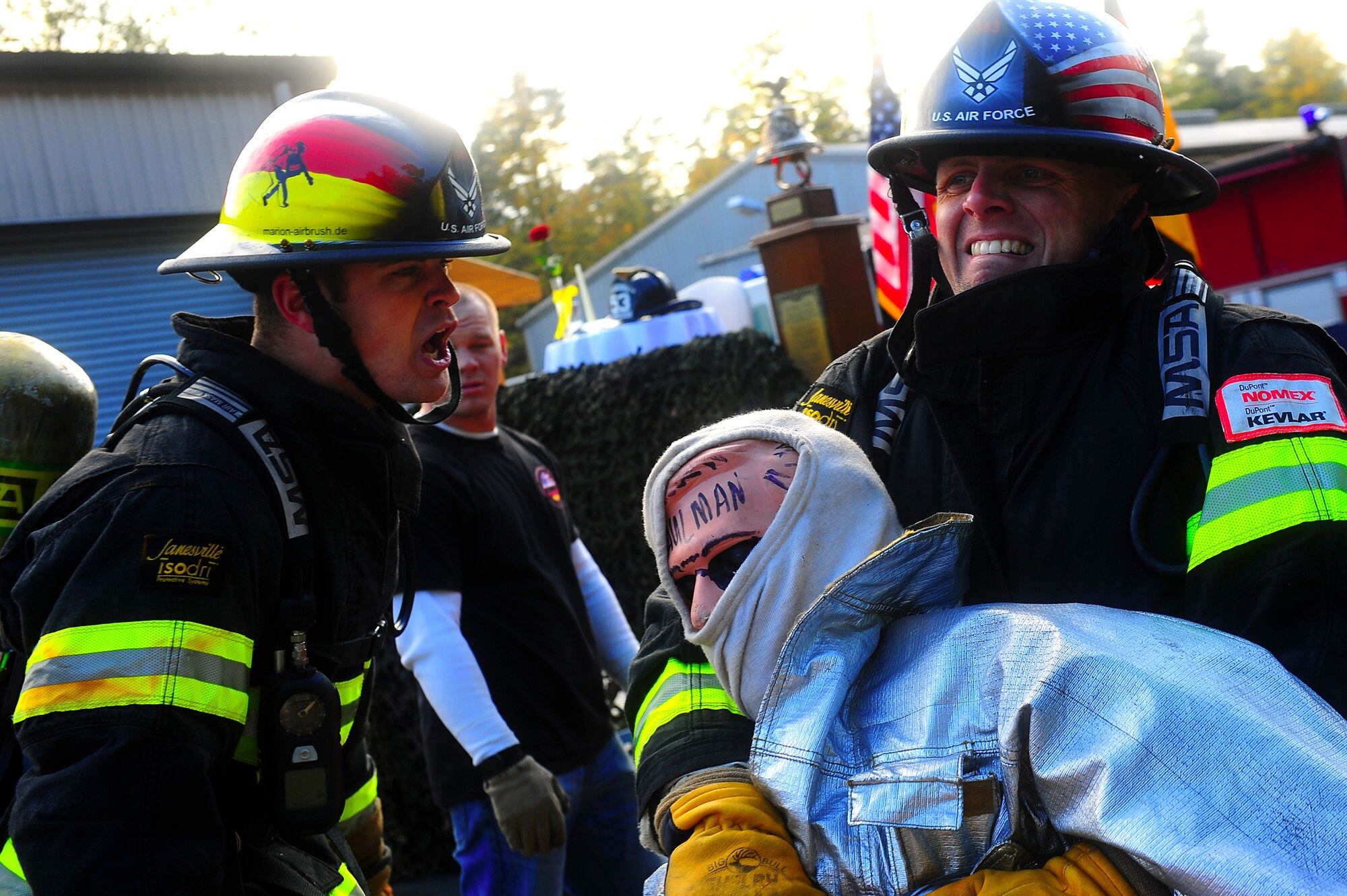 Air Force Airman 1st Class Steven Vandenburgh, 52nd Civil Engineer Squadron firefighter, motivates teammate, Staff Sgt. Daniel Jones, as he carries a simulated victim 100 feet during the 435th Construction and Training Squadron Firefighter Combat Challenge, Ramstein Air Base, Germany, Oct. 20, 2011. The event promoted physical fitness and enhanced camaraderie between firefighters within U.S. Air Forces in Europe. Winners will continue on to the final challenge held in Myrtle Beach, S.C., Nov. 14-19, 2011. (U.S. Air Force photo by Airman 1st Class Brea Miller)