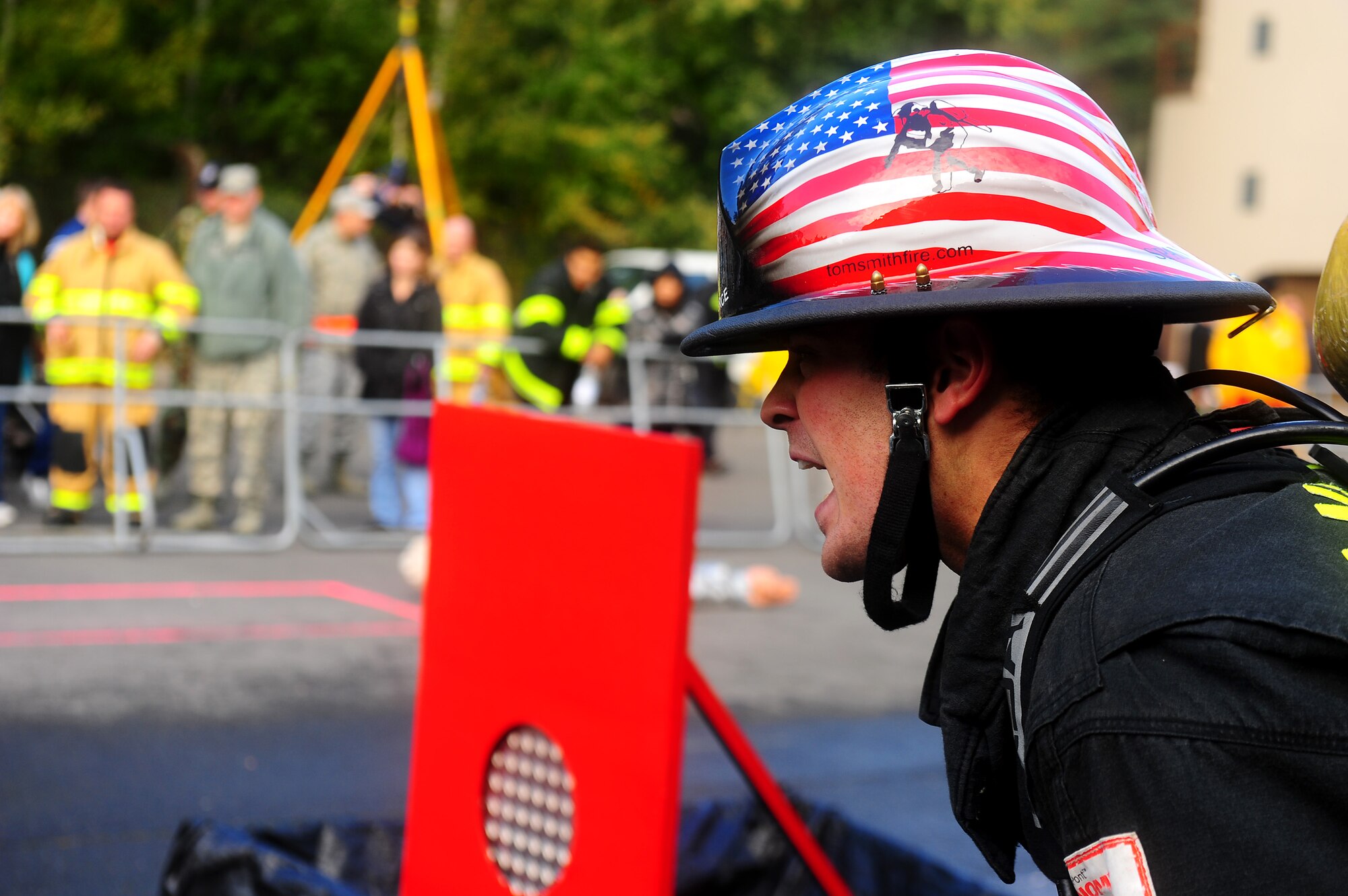 Air Force Airman 1st Class Steven Vandenburgh, 52nd Civil Engineer Squadron firefighter, encourages a teammate during the 435th Construction and Training Squadron Firefighter Combat Challenge, Ramstein Air Base, Germany, Oct. 20, 2011. The event promoted physical fitness and enhanced camaraderie between firefighters within U.S. Air Forces in Europe. Winners will continue on to the final challenge held in Myrtle Beach, S.C., Nov. 14-19, 2011. (U.S. Air Force photo by Airman 1st Class Brea Miller)