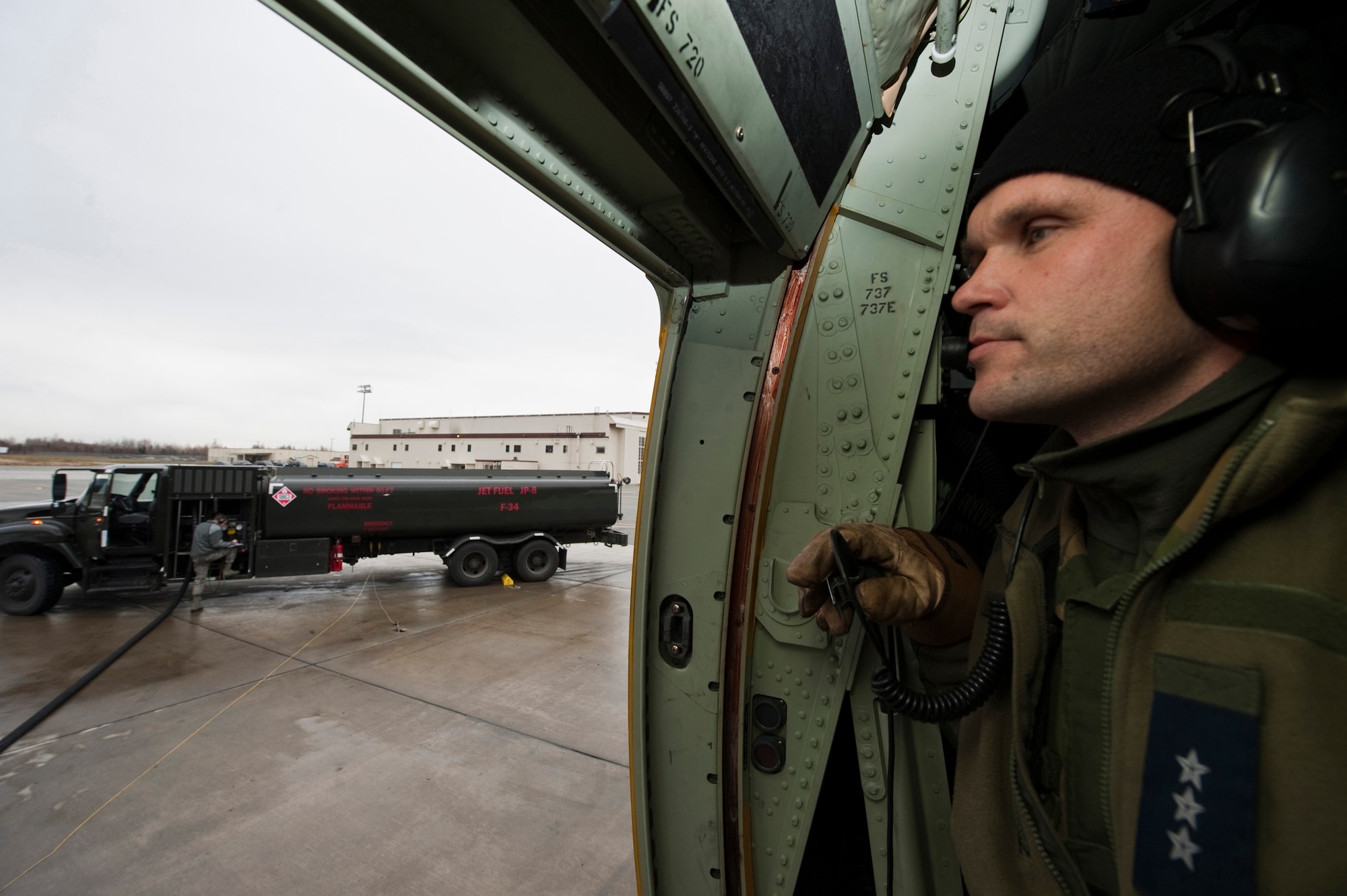 JOINT BASE ELMENDORF-RICHARDSON, Alaska -- Royal Norwegian Air Force Capt. Morten Johansen, 135th Air Wing, Gardermoen Air Station, Norway, looks on as U.S. Air Force Senior Airman Jonathan Macpheron, 673 Logistics Readiness Squadron, refuels  RNAF's C-130 Hercules during Red Flag-Alaska Oct. 13. This was the first time the RNAF has participated in RF-Alaska. Twenty-three airmen from the 135th Air Wing participated in the exercise Oct. 6 to Oct. 21. (U.S. Air Force photo/Senior Airman Christopher Gross)