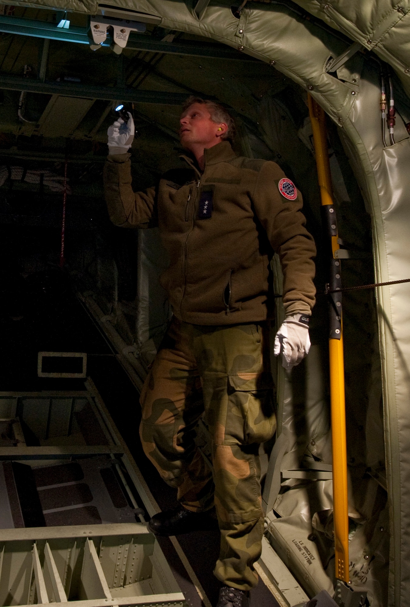 JOINT BASE ELMENDORF-RICHARDSON, Alaska -- Royal Norwegian Air Force Capt. Andre Pedersen, 135th Air Wing, Gardermoen Air Station, Norway, checks out the back of a C-130 Hercules during post-flight maintenance during Red Flag-Alaska Oct. 13. This was the first time the RNAF has participated in RF-Alaska. Twenty-three airmen from the 135th Wing participated in the exercise Oct. 6 to Oct. 21. (U.S. Air Force photo/Senior Airman Christopher Gross)