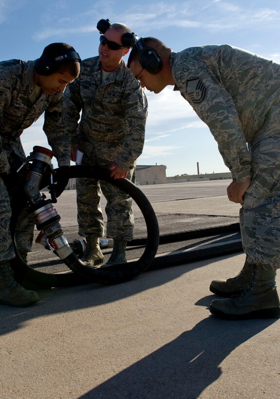 Master Sgt. Ronald Killen, U.S. Air Force Logistics Compliance Assessment Program team leader, monitors Airman 1 st Class Ethan Brown and Tech. Sgt. Sean Tryner, 28 th Logistics Readiness Squadron fuels distribution technicians, during an inspection at Ellsworth Air Force Base, S.D., Oct. 5, 2011. The inspection focused on checklist compliance, quality verification, and personnel evaluations within the base’s supply, transportation, fuels, munitions, and readiness units. (U.S. Air Force Photo by Airman 1st Class Kate Thornton/Released)

