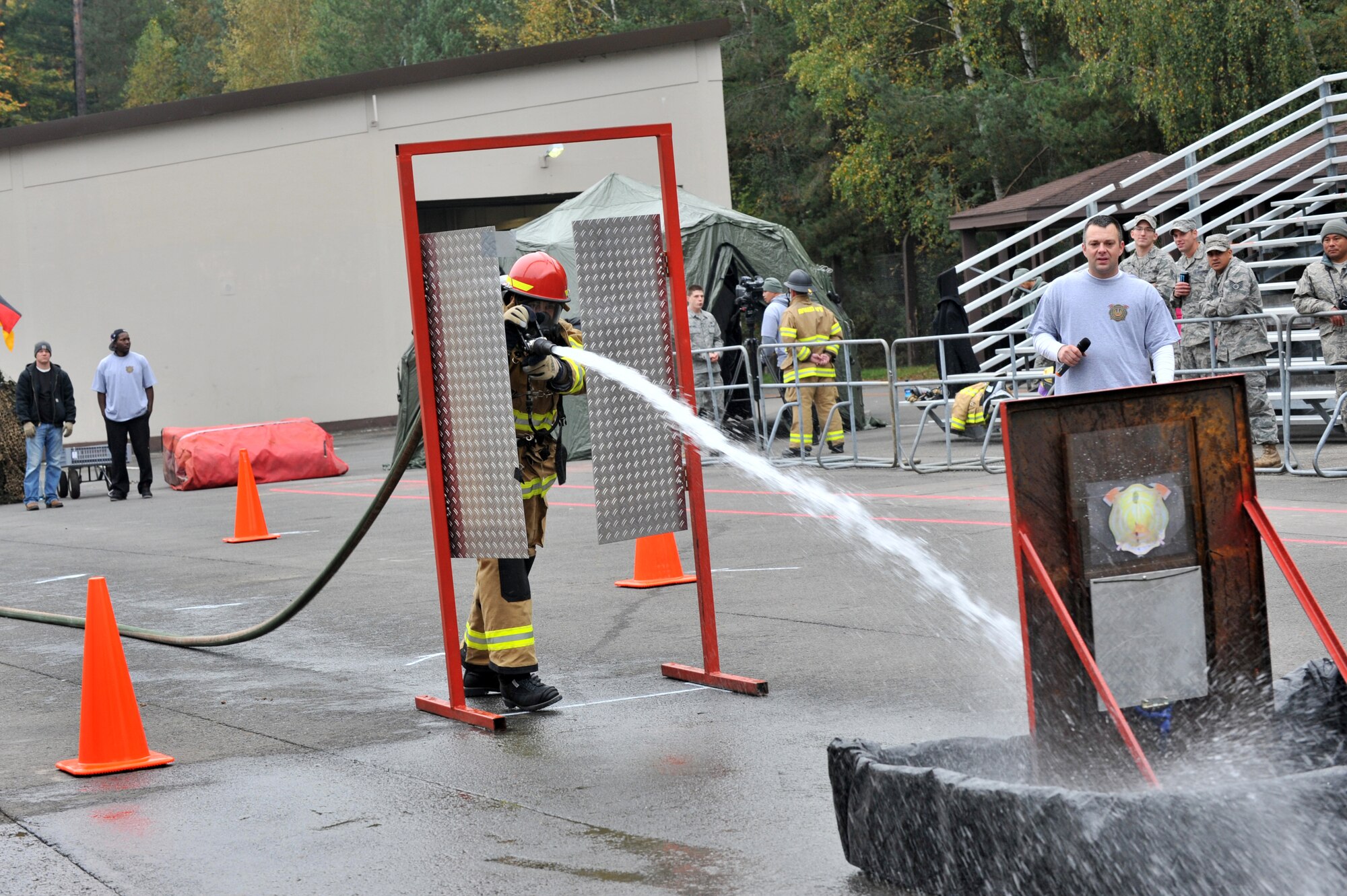 Air Force Airman Tyler Lamberson, 52nd Civil Engineer Squadron, firefighter, sprays water at a fixed target during the 435th Construction and Training Firefighter Combat Challenge, Ramstein Air Base, Germany, Oct. 20, 2011. The event promoted physical fitness and enhanced camaraderie between firefighters within U.S. Air Forces in Europe. The winners will continue on to the final challenge held in Myrtle Beach, S.C., Nov 14-19, 2011. (U.S. Air Force photo by Airman First Class Caitlin O'Neil-McKeown)