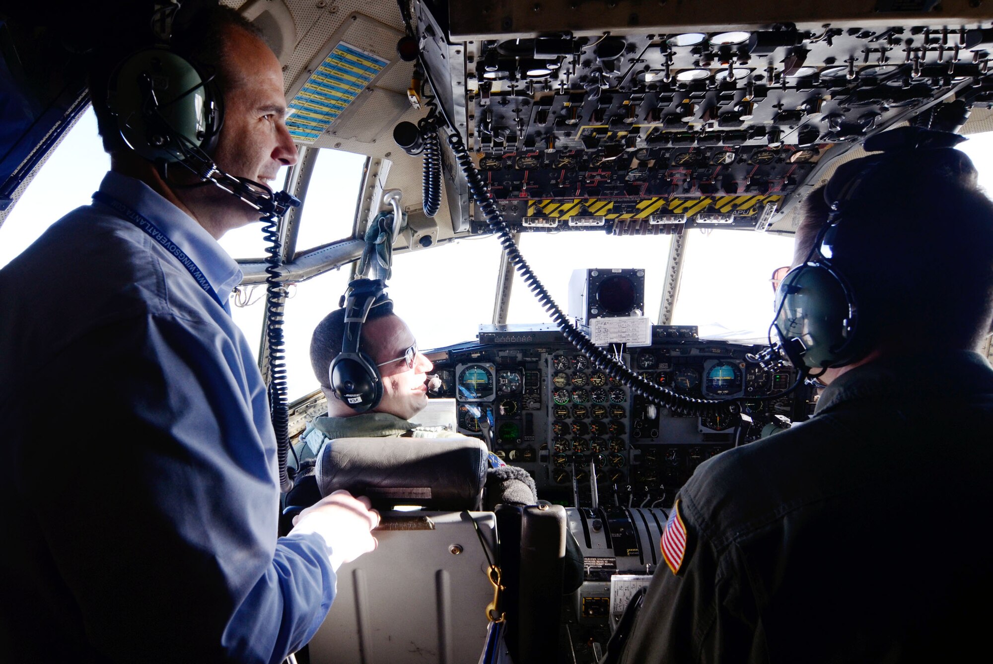 Civic leaders observe activities in the cockpit while in flight to Niagara Falls Air Reserve Station, NY, during the Civic Leader Tour, Oct. 13-14 that was sponsored by the 94th Airlift Wing, Dobbins Air Reserve Base, Ga. (U.S. Air Force photo/Don Peek) 