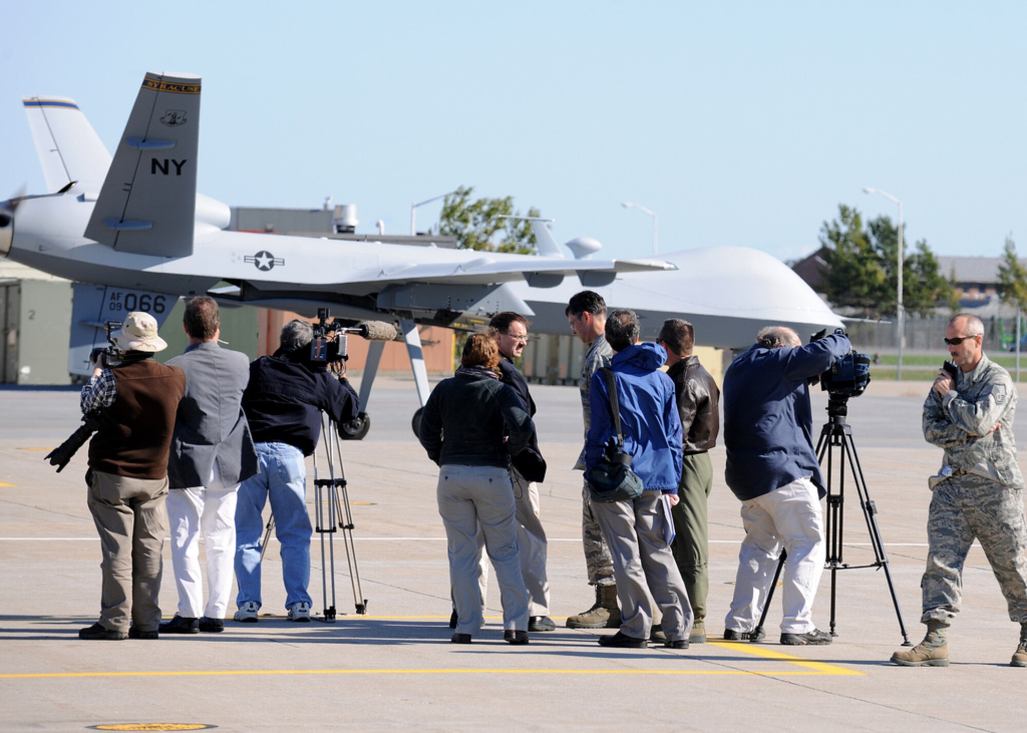 Members of the media look on as MQ-9 taxis along the flight line at Wheeler Sack Army-Air Field on Ft. Drum NY on 5 Oct 2011. 