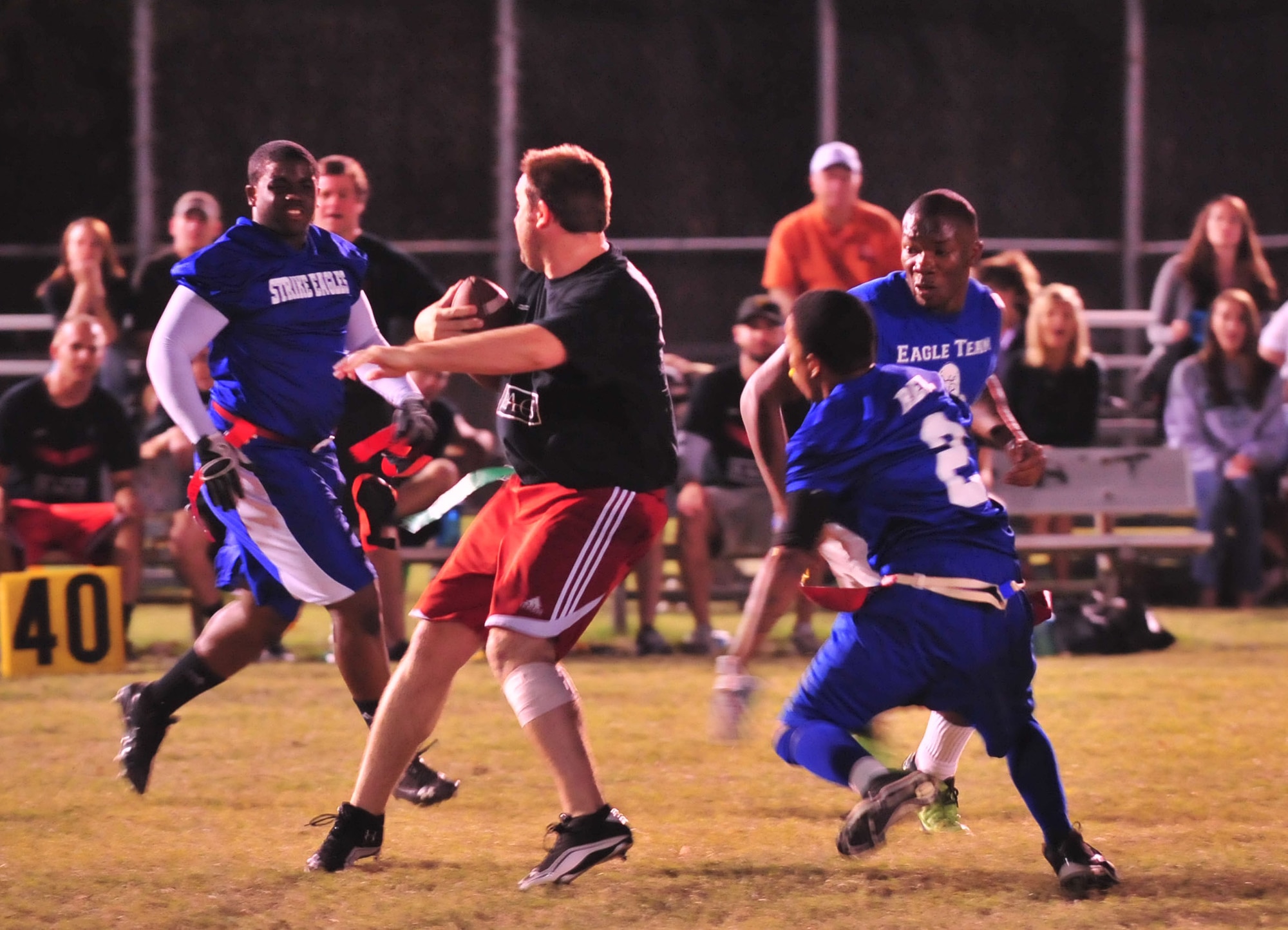 Members of the Seymour Johnson Strike Eagle flag football team close in on a member of the RAGS clothing company flag football team, during the Goldsboro, N.C., championship game, Oct. 17, 2011, at Mina Weil Park. The Strike Eagles defeated the RAGS team 7-6. (U.S. Air Force photo by Senior Airman Marissa Tucker)