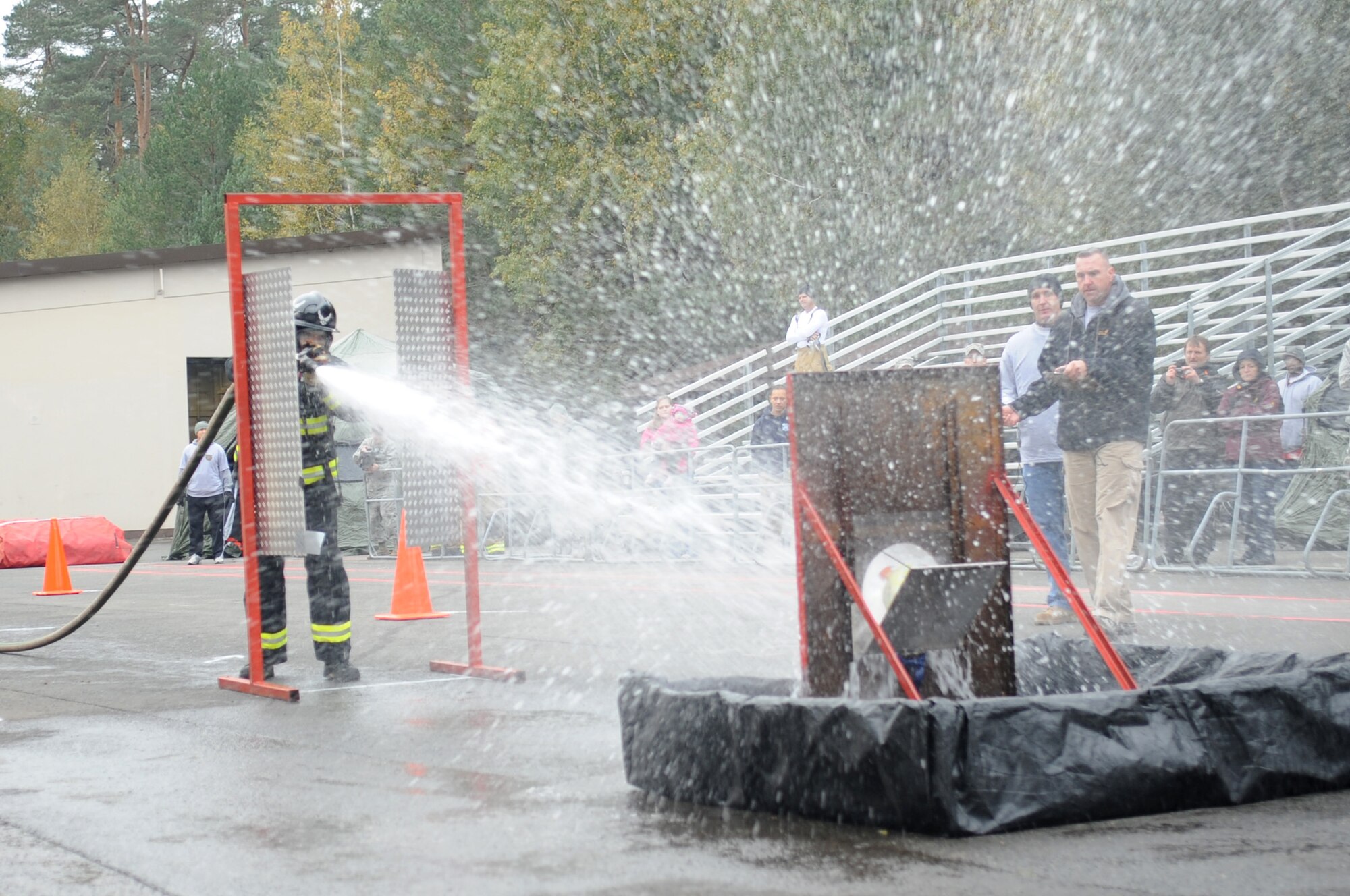 Air Force Staff Sgt. Jeremy Noah, 886th Civil Engineer Squadron firefighter, aims for a target through a swing door during the 435th Construction and Training Squadron Firefighter Combat Challenge, Ramstein Air Base, Germany, Oct. 20, 2011. The event promoted physical fitness and enhanced camaraderie between firefighters within U.S. Air Forces in Europe. Winners will continue on to the final challenge held in Myrtle Beach, S.C., Nov 14-19, 2011. (U.S. Air Force photo by Senior Airman Brittany Perry)