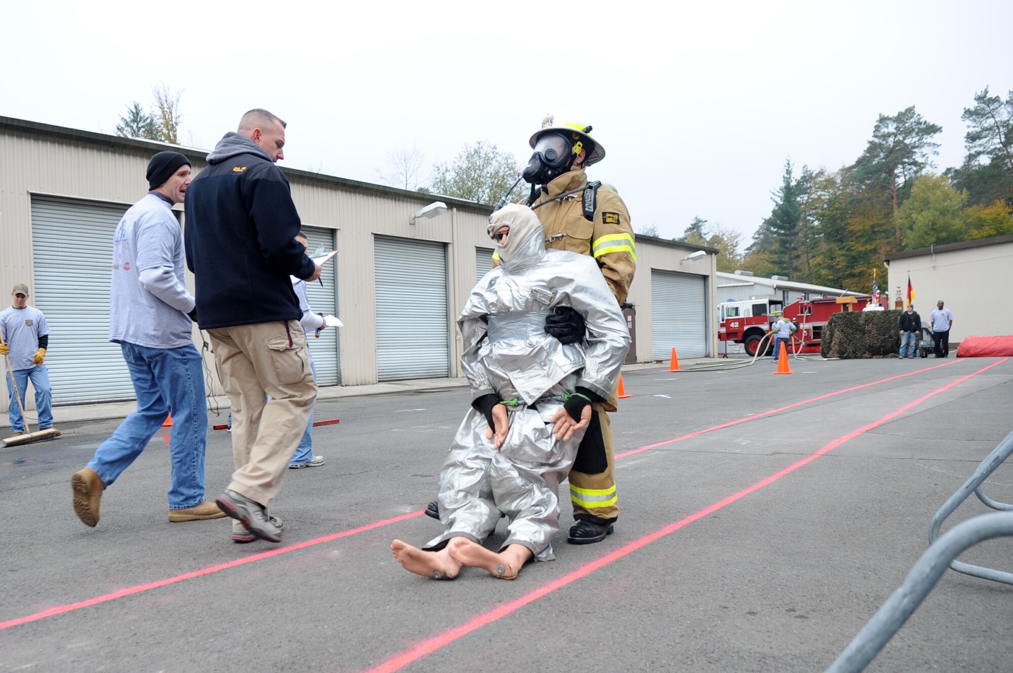 Air Force Master Sgt. Lloyd Stinson, 31st Civil Engineer Squadron firefighter, carries a simulated victim 100 feet during the 435th Construction and Training Squadron Firefighter Combat Challenge, Ramstein Air Base, Germany, Oct. 20, 2011. The event promoted physical fitness and enhanced camaraderie between firefighters within U.S. Air Forces in Europe. Winners will continue on to the final challenge held in Myrtle Beach, S.C., Nov 14-19, 2011. (U.S. Air Force photo by Senior Airman Brittany Perry)