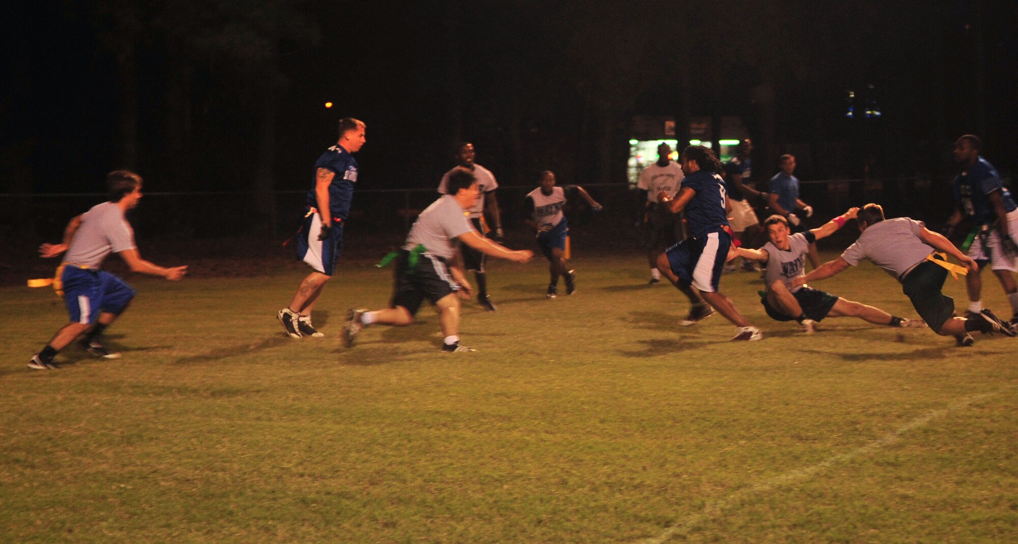 Members of the Strike Eagle flag football team advance toward the end zone during a game against the Wayne Community College flag football team at Mina Weil Park in Goldsboro, N.C., Oct. 5, 2011. The Strike Eagle flag football team is Seymour Johnson Air Force Base’s varsity football team and consists of Airmen and civilians associated with the wing. The team finished the season with a 7-1 record and is the flag football city champions. (U.S. Air Force photo by Senior Airman Marissa Tucker)
