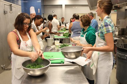 More than 20 Airmen and their families participate in a free cooking class Sept. 24 at the Culinary Institute of Charleston. The class, themed ‘Cooking Healthy on a Budget’ was provided by the Joint Base Charleston Health and Wellness Center and taught by local chef Ken Immer. Courtesy photo 