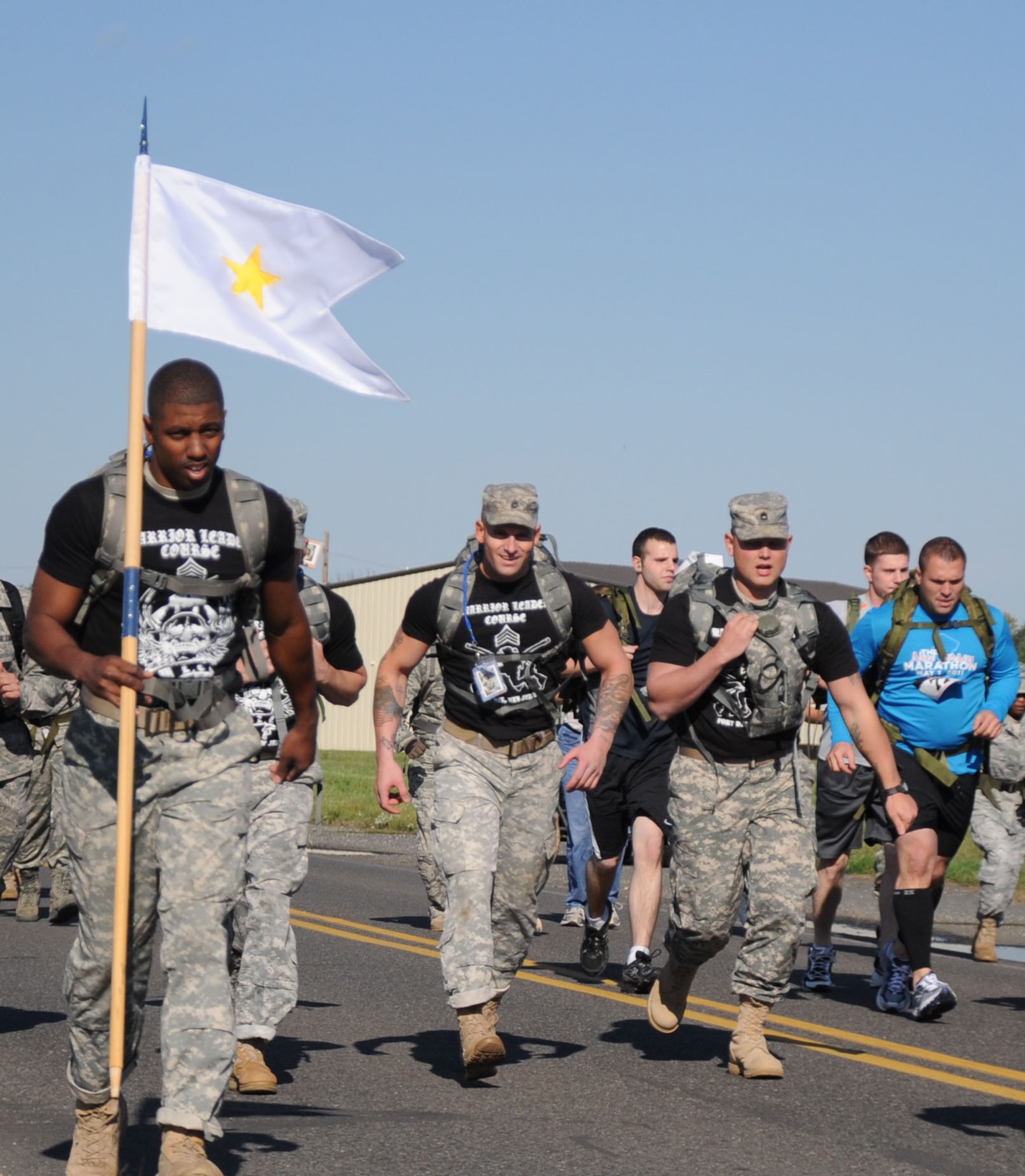 The Noncommissioned Officer Academy Team, Staff Sgt. Elit Pierre, Sgt. 1st Class Christopher Hill, Staff Sgt. Christopher Trammell and Sgt. 1st Class Brud Nicki, run with the Gold Star Mother’s Flag in the 5th Annual Gold Star Mother’s Ruck March Oct. 15. The NCO Academy team was running to honor Gold Star Mother Diane Fenton, from Little Ferry N.J., and her son Marine Sgt. Matthew J. Fenton who died from wounds received while conducting combat operation in Anbar province, Iraq. (U.S. Air Force photo by James L. Hodges/Released)