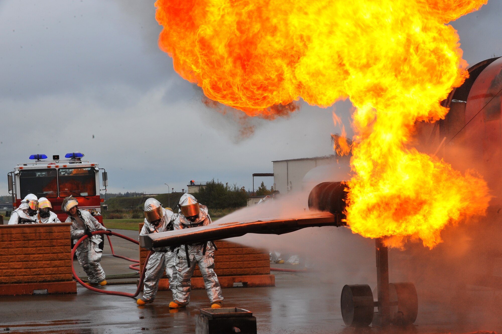 RAMSTEIN AIR BASE, Germany – Firefighters from the 52nd Civil Engineer Squadron Fire Protection Flight extinguish an engine fire on a mock aircraft during live fire training here Oct. 19. Live fire training is mandatory for firefighters to complete twice a year. The training ensures firefighters are able to perform required core tasks in the event of an aircraft fire to protect lives and U.S. government assets. (U.S. Air Force photo/Airman 1st Class Dillon Davis)