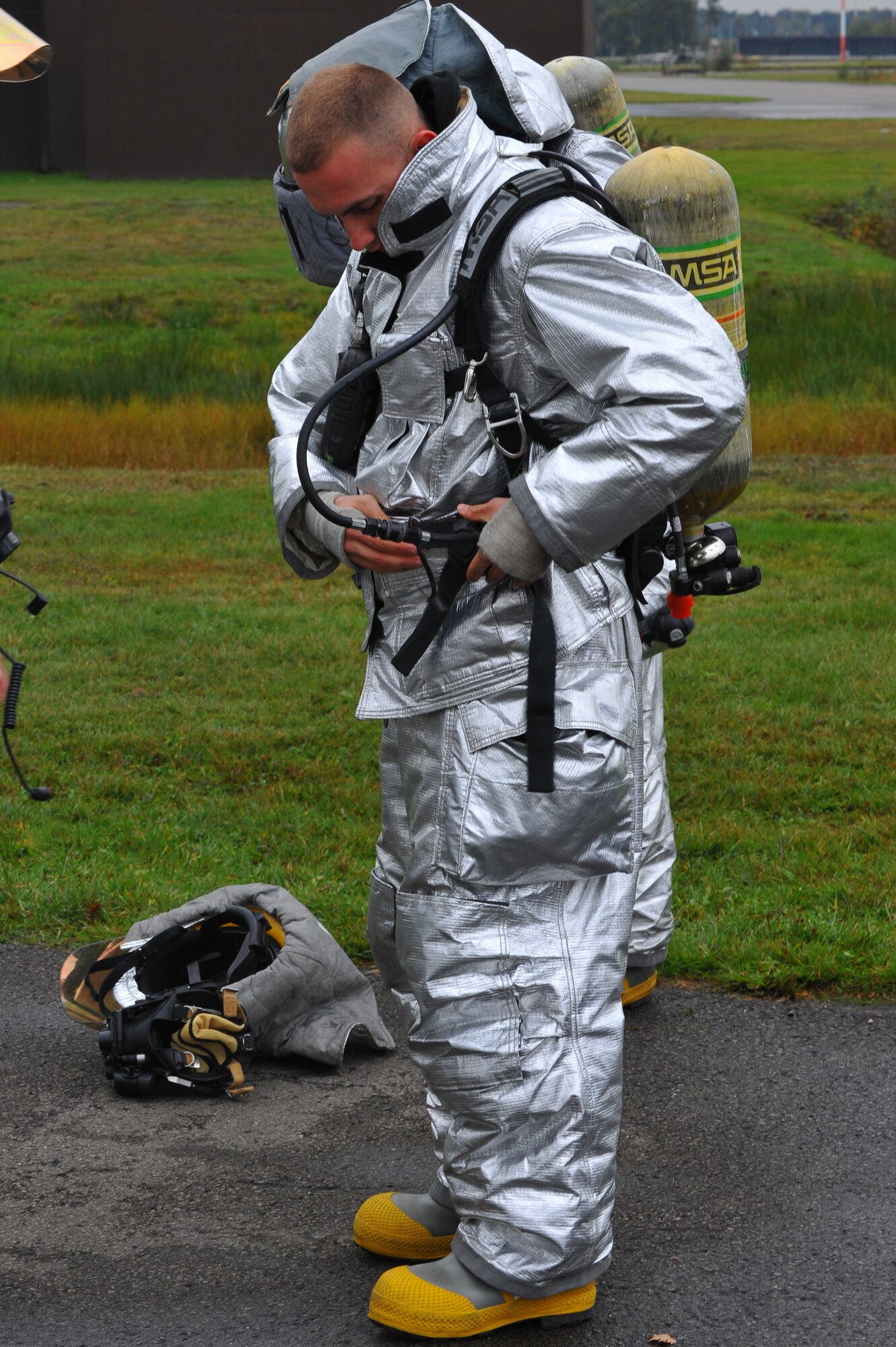 RAMSTEIN AIR BASE, Germany – Airman 1st Class Brien Tarkington, 52nd Civil Engineer Squadron firefighter, gears up before live fire training here Oct. 19. Live fire training is mandatory for firefighters to complete twice a year. The training ensures firefighters are able to perform required core tasks in the event of an aircraft fire to protect lives and U.S. government assets. (U.S. Air Force photo/Airman 1st Class Dillon Davis)