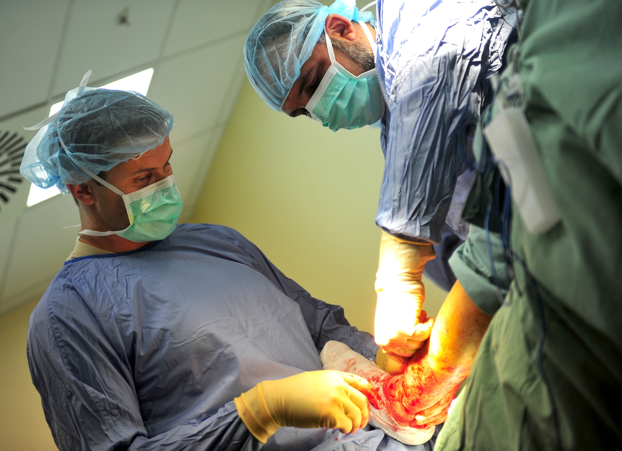 Maj. Andy Malin performs an orthopedic surgery alongside an Afghan doctor at the Afghan National Army Hospital in Herat, Afghanistan, Oct. 10, 2011. Malin is an Air Force Special Operations surgical team orthopedic surgeon, deployed from Hurlburt Field, Fla. The SOST team provides medicine to disadvantaged people, provides direct patient care, and builds relationships with local doctors. (U.S. Air Force Photo/Senior Airman Tyler Placie)