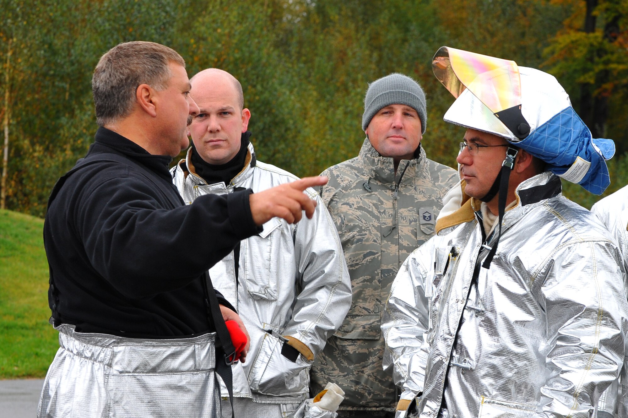 RAMSTEIN AIR BASE, Germany – Dieter Bestyak, left, 886th Civil Engineer Squadron Fire Protection Flight training officer, briefs firefighters from the 52nd CES before live fire training here Oct. 19. Live fire training is mandatory for firefighters to complete twice a year. The training ensures firefighters are able to perform required core tasks in the event of an aircraft fire to protect lives and U.S. government assets. (U.S. Air Force photo/Airman 1st Class Dillon Davis)