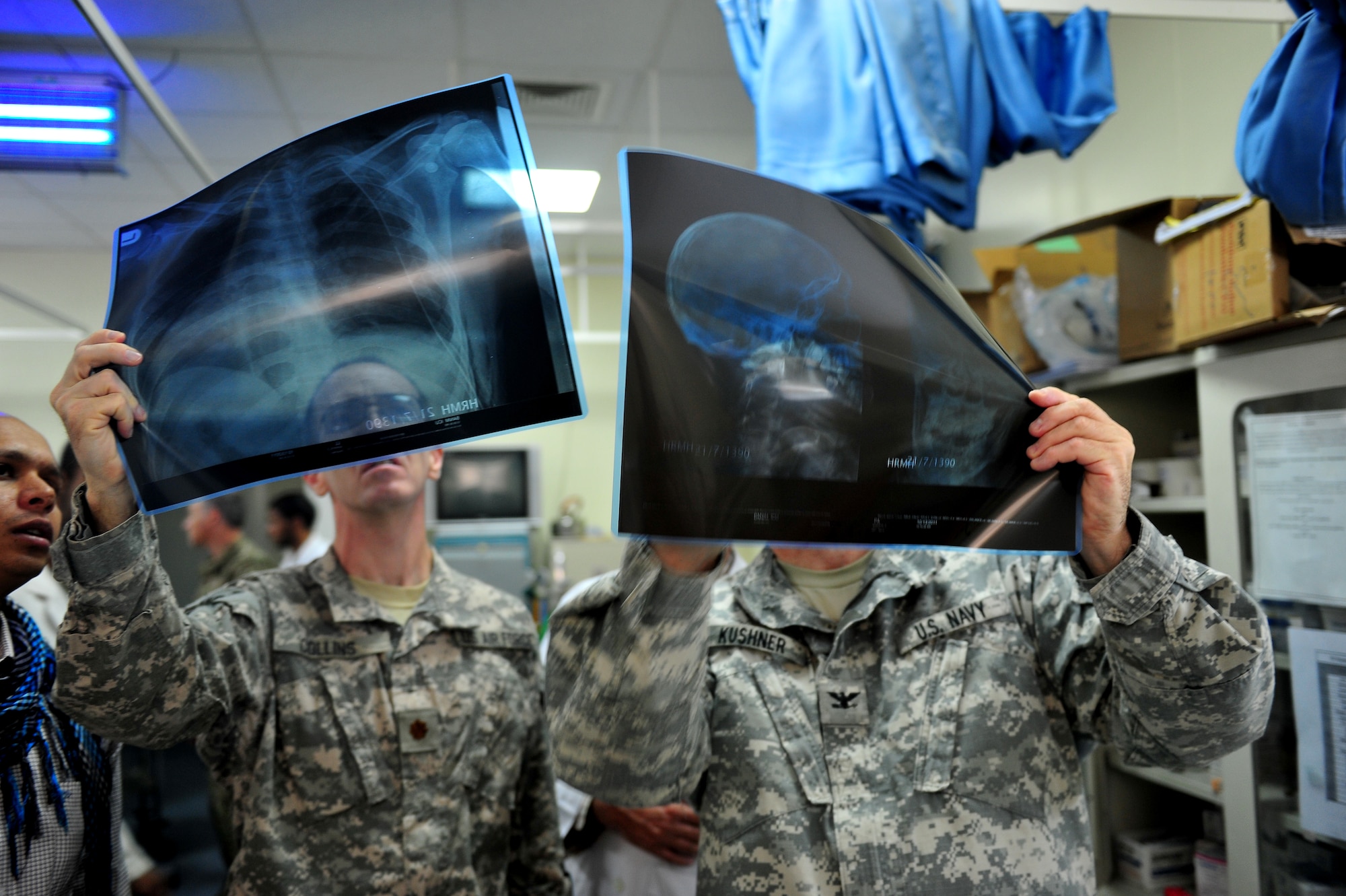 Maj. Jeffrey Collins compares X-rays, with Navy Capt. Christopher Kushner, at Herat's Afghanistan National Army Hospital intensive care unit Oct. 10, 2011. Collins is part of the Special Operations Surgical Team, deployed from Hurlburt Field, Fla. The SOST team provides medicine to disadvantaged people, provides direct patient care, and builds relationships with local doctors. (U.S. Air Force Photo/Senior Airman Tyler Placie)