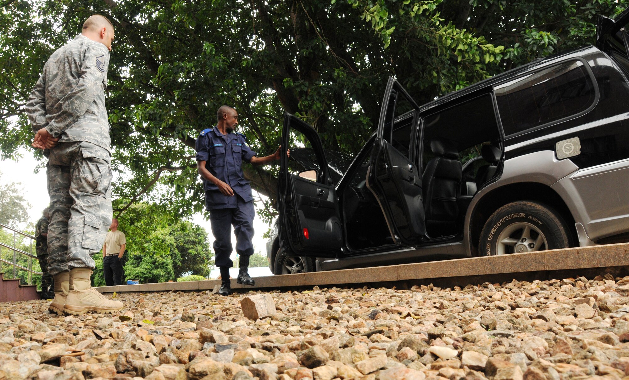 KIGALI, Rwanda – Master Sgt. Garrett Smith, theater security events manager for the 17th Air Force Security Forces Division, acts as a handcuffed driver during a scenario where Rwandan National Police and Defense Force perform a vehicle search Oct. 12, 2011. The week-long event provided an exchange of ideas between USAF Security Forces, 25 RDF officers and three civil police officers attending the event. Two days of classroom activity provided information on the basics of defending an airbase, principles of defense and vehicle searches. The remaining two days of hands-on training put those techniques into practical application perspective. (U.S. Air Force photo by Staff Sgt. Stefanie Torres)