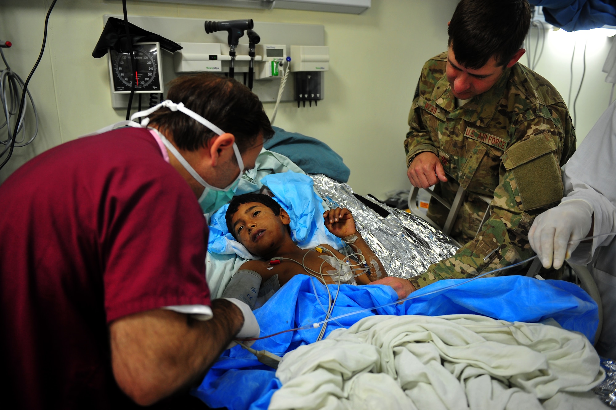 Maj. Jason Webb advises an Afghan doctor during the care of a young Afghan child at Herat's Afghanistan National Army hospital, Oct. 10, 2011. Webb is an Air Force Special Operations surgical team general surgeon deployed from Hurlburt Field, Fla. The SOST team provides medicine to disadvantaged people, provides direct patient care, and builds relationships with local doctors. (U.S. Air Force Photo/Senior Airman Tyler Placie)