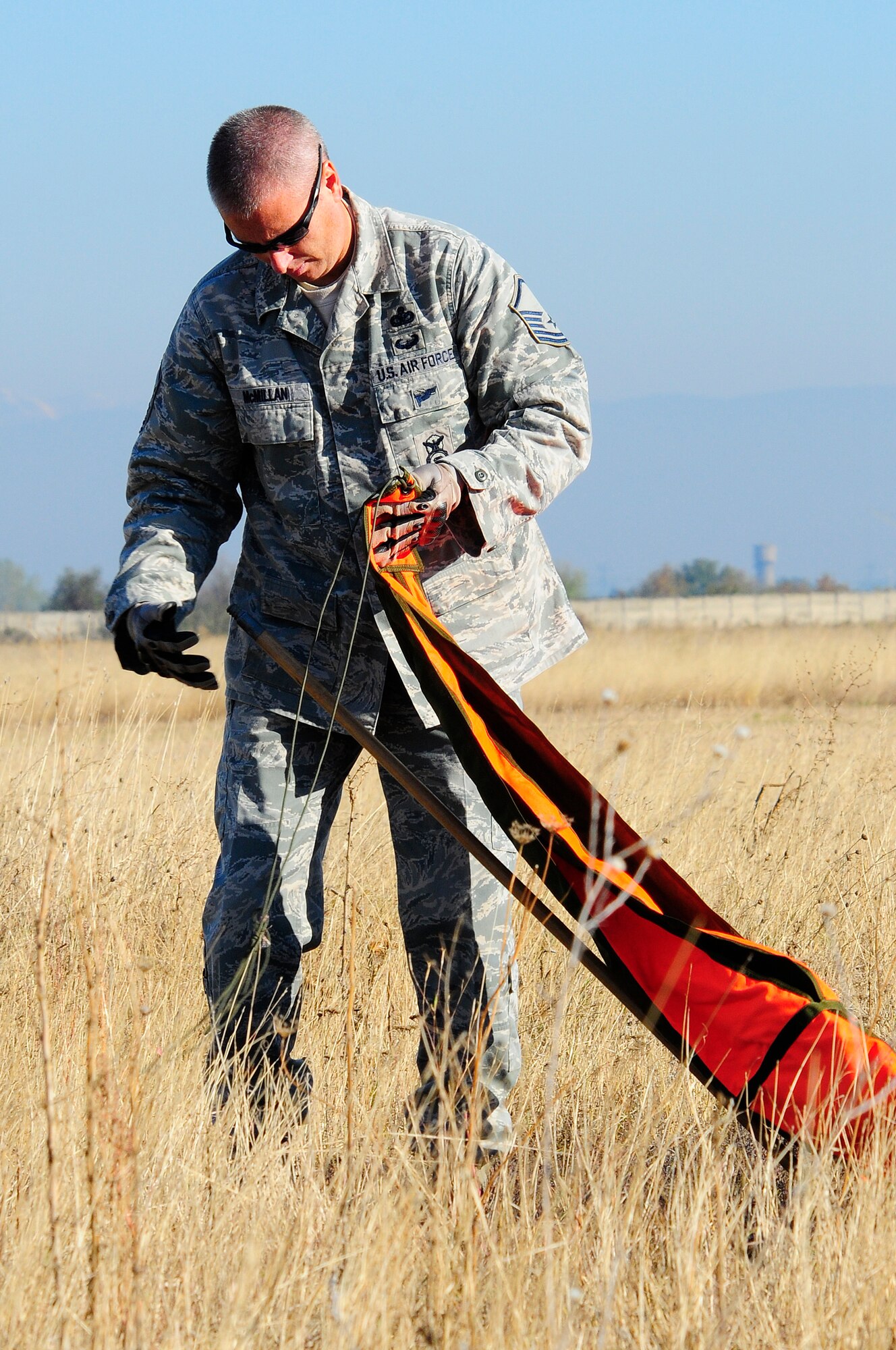 Master Sgt. Greg McMillan, Operation Thracian Fall 2011 drop zone team lead, sets up the drop zone mark for parajumpers to land on in Plovdiv, Bulgaira, Oct. 19, 2011. OTF11 is off-station training designed to enhance interoperability between U.S. and Bulgarian Air Forces as well as build partnerships with paratroopers from both. (U.S. Air Force photo by Staff Sgt. Travis Edwards)
