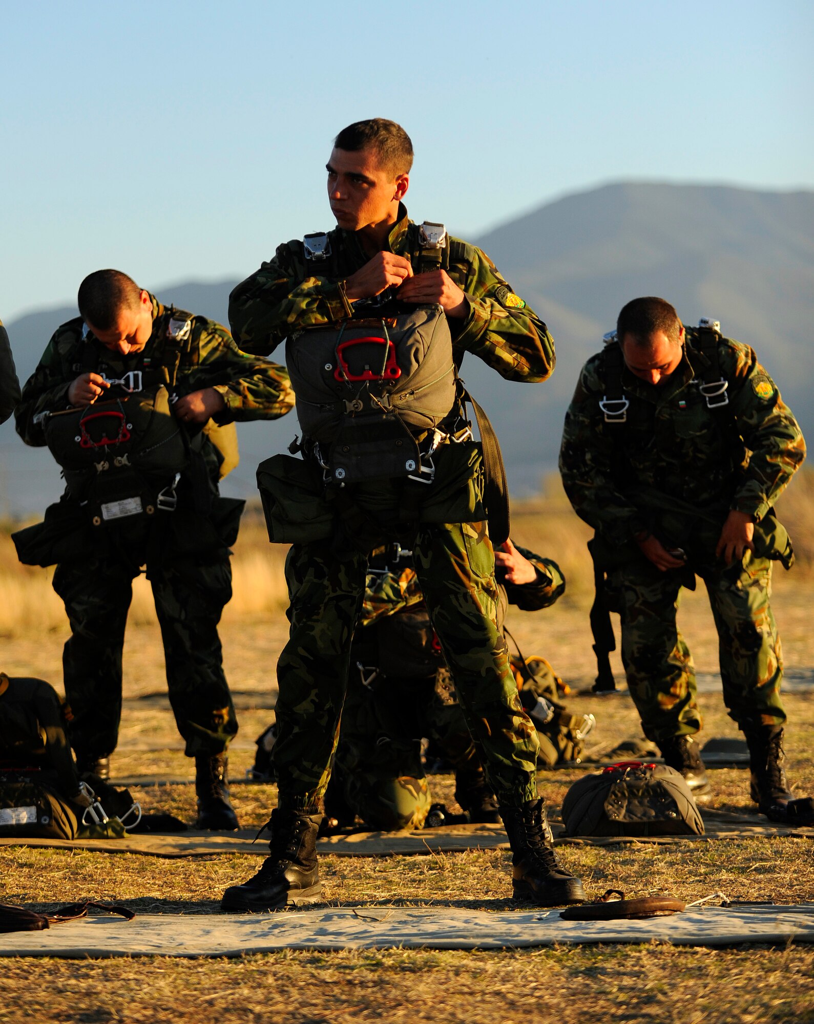 Bulgarian parartroopers don static-line parachutes during Operation Thracian Fall 2011, Oct. 19, 2011 in Plovdiv, Bulgaria. OTF11 is off-station training designed to enhance interoperability between U.S. and Bulgarian Air Forces as well as build partnerships with paratroopers from both. (U.S. Air Force photo by Senior Airman Stephen J. Otero)