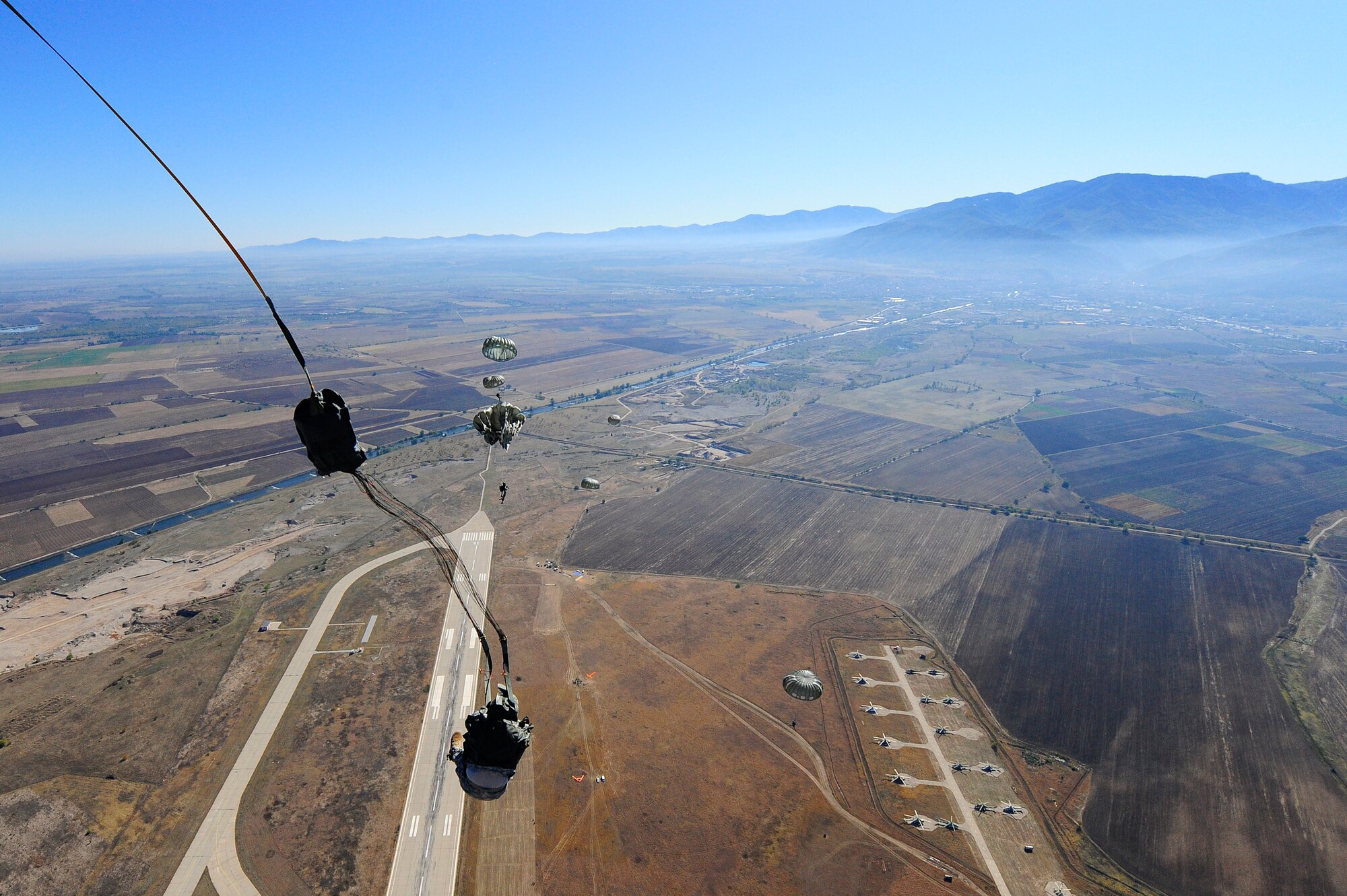 U.S. Army and Bulgarian air force paratroopers float to the ground after jumping from a C-130J Super Hercules aircraft during Operation Thracian Fall 2011, Oct. 19, 2011, Plovdiv, Bulgaria. OTF11 is off-station training designed to enhance interoperability between U.S. and Bulgarian Air Forces as well as build partnerships with paratroopers from both. (U.S. Air Force photo by Senior Airman Stephen J. Otero)