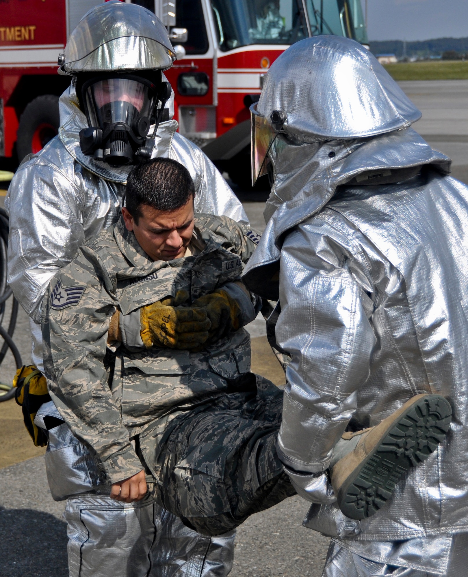 YOKOTA AIR BASE, Japan -- Staff Sgt. Marcos Alonso, 374th Civil Engineer Squadron firefighter, simulates an injury during a fire exercise at Yokota Air Base, Japan, Oct. 18, 2011. The 374th CES regularly trains in aircraft fire response and must be prepared for situations such as rescuing victims. (U.S. Air Force photo/Airman John D. Partlow)