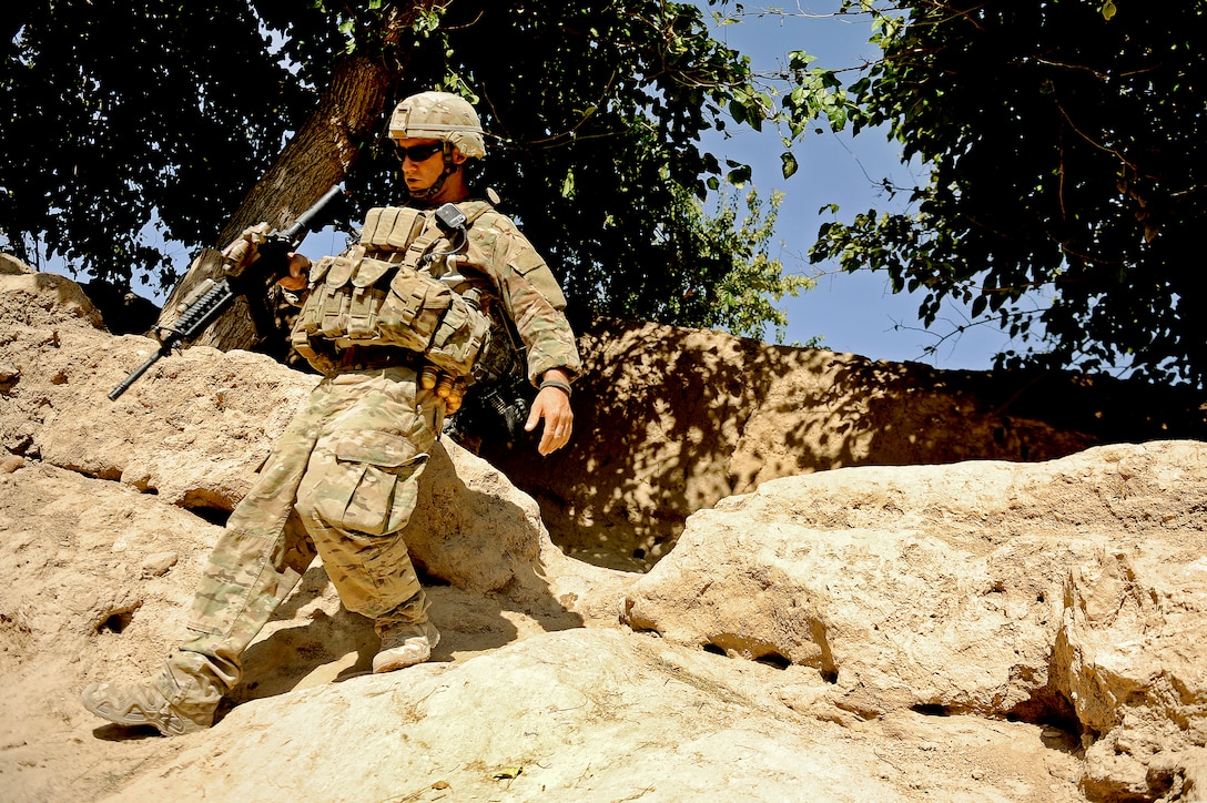 U.S. Army Sgt. Michael Lovett climbs down a hill during a patrol in a local village in Mizan district, Afghanistan, Oct. 20, 2011. Lovett is a team leader assigned to Provincial Reconstruction Team Zabul, and deployed from Company C, 182nd Infantry Regiment, Massachusetts National Guard.