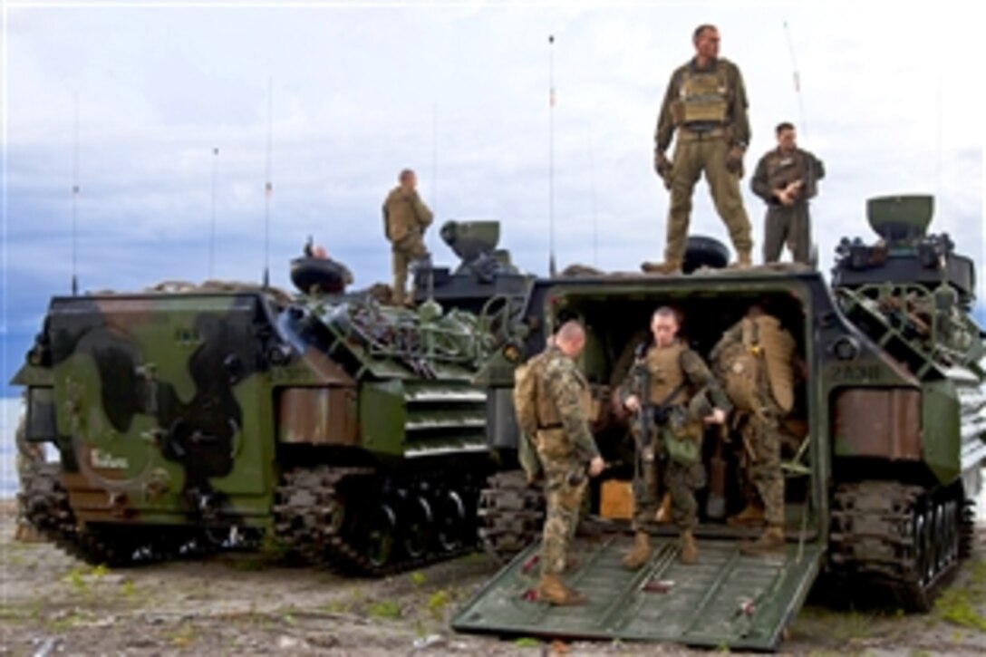 U.S. Marines check their gear during a break in training in Turbo, Colombia, Oct. 10, 2011. The Marines are embarked aboard the amphibious dock landing ship USS Oak Hill, which is participating in Southern Partnership Station, an annual deployment of U.S. military training teams to the U.S. Southern Command area of responsibility in the Caribbean and Latin America. 