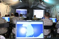Marine Aircraft Group 12 S-2, S-3 and S-6 Marines recieve a period of instruction from John W. Lynch III, Combat Operations Center specialist, Marine Integrated Systems Training Center Okinawa, Japan, during a command and control systems course in the MAG-12 Operations Center exercise at Penny Lake Fields here Oct. 20. Marines were trained to use both Command and Control Personal Computer (C2PC) and Command Post of the Future (CPOF) operating systems.