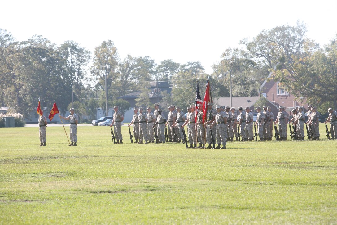 Marines with 3rd Battalion, 9th Marine Regiment, 2nd Marine Division, stand in formation just before a change of command ceremony for the battalion. During the ceremony, 3/9 bid farewell to Lt. Col. David Hudspeth and welcomed Lt. Col. Carl Cooper.
