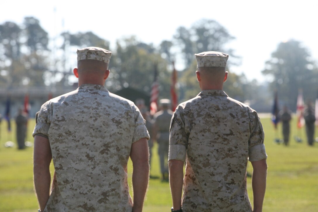 Lt. Col. David Hudspeth, former commanding officer of 3rd Battalion, 9th Marine Regiment, 2nd Marine Division, and Lt. Col. Carl Cooper, incoming commanding officer of 3/9, stand at the position of attention during a change of command ceremony, Oct. 21. During the ceremony, 3/9 bid farewell to Hudspeth and welcomed Cooper.