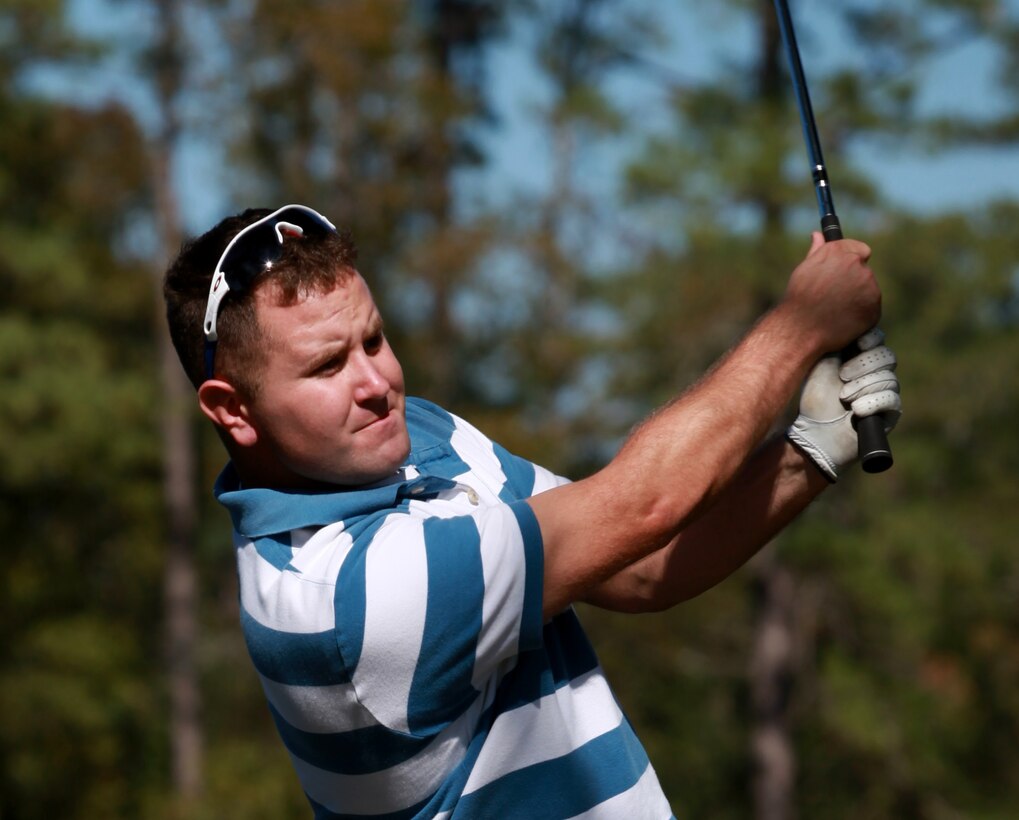 Corporal Mark B. Baker, staff secretary, Headquarters Battalion, 2nd Marine Division, watches his ball after teeing off during a golf tournament aboard Marine Corps Base Camp Lejeune, N.C., Oct. 21, 2011. The tournament was held to help raise money for their upcoming Marine Corps Ball and gave the Marines a day to relax and play a game of golf.