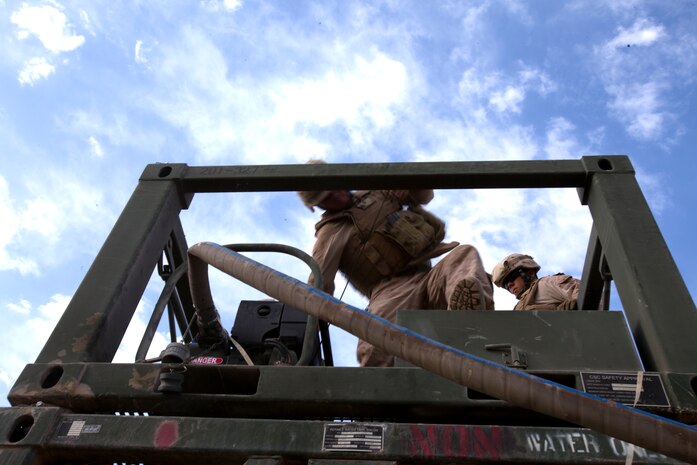 Sgt. Eric Zauner, a native of Greendale, Wis., starts a motor in the Helmand River valley of southwestern Afghanistan, working to build a helicopter landing zone for a special operations outpost in the Helmand River valley of southwestern Afghanistan, Oct. 21. Zauner, from Greendale, Wis., serves as the senior motor vehicle operator for a roughly 20-man team dubbed “Task Force Nomad.” Over the next several weeks, the task force, a subset of Marine Wing Support Squadron 371, will construct or improve helicopter landing zones along the Helmand River valley in southwestern Afghanistan.