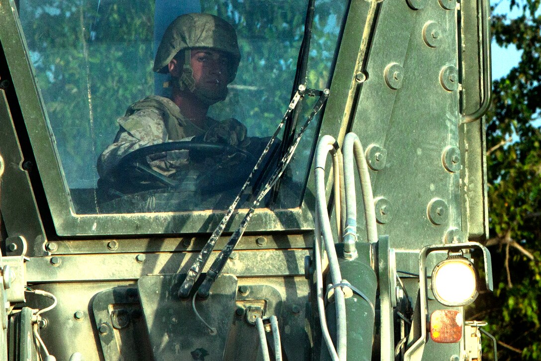 Cpl. Christopher Cane constructs a helicopter landing zone in the Helmand River valley of southwestern Afghanistan from behind the wheel of an armored bulldozer, Oct. 21. Cane, a native of Olympia, Wash., is a heavy equipment operator on a roughly 20-man team dubbed “Task Force Nomad.” Over the next several weeks, the task force, a subset of Marine Wing Support Squadron 371, will construct or improve helicopter landing zones along the Helmand River valley in southwestern Afghanistan.